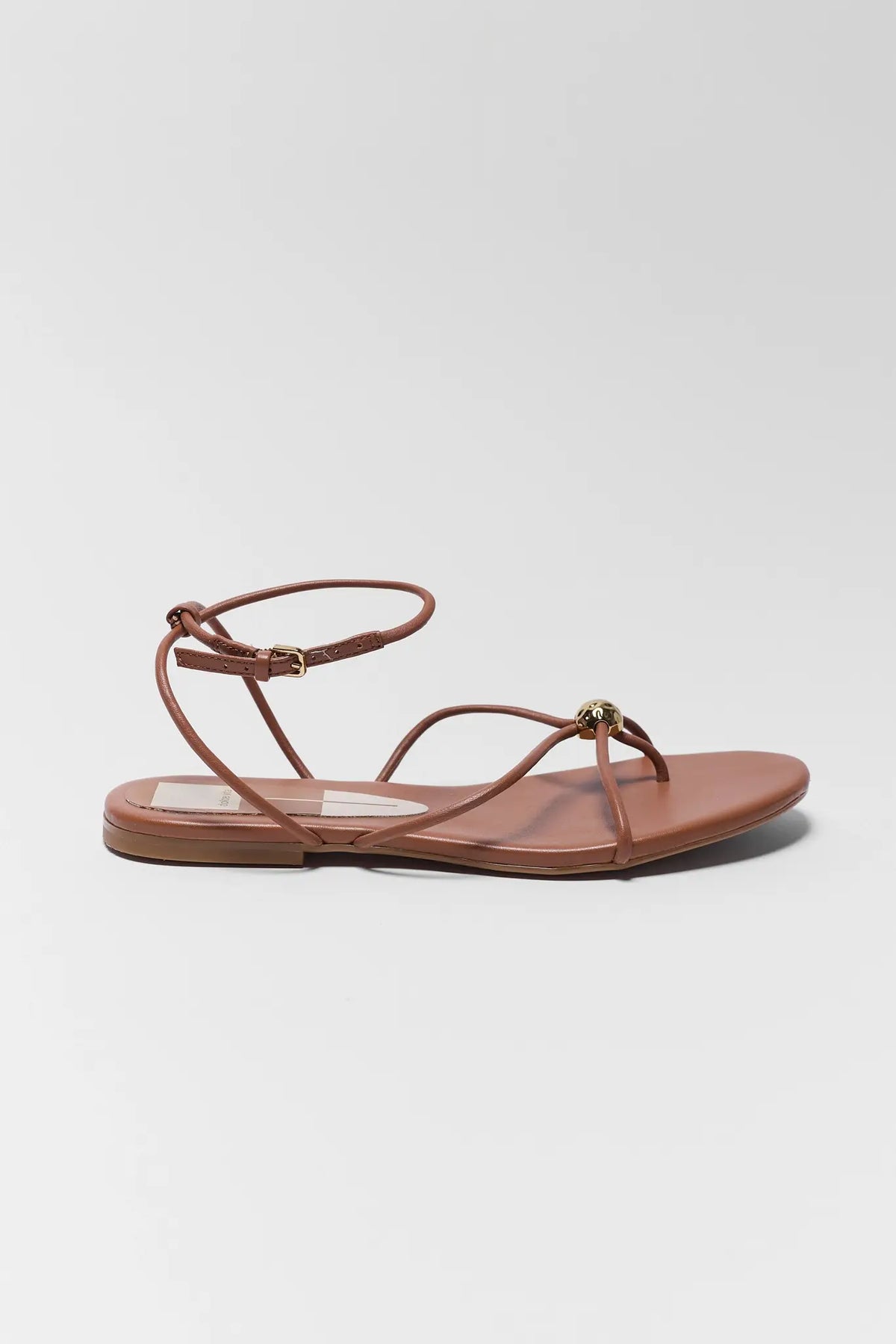 Dolce Vita Kenley brown leather strappy flat sandal with ankle strap and gold detail - Side View | Avara