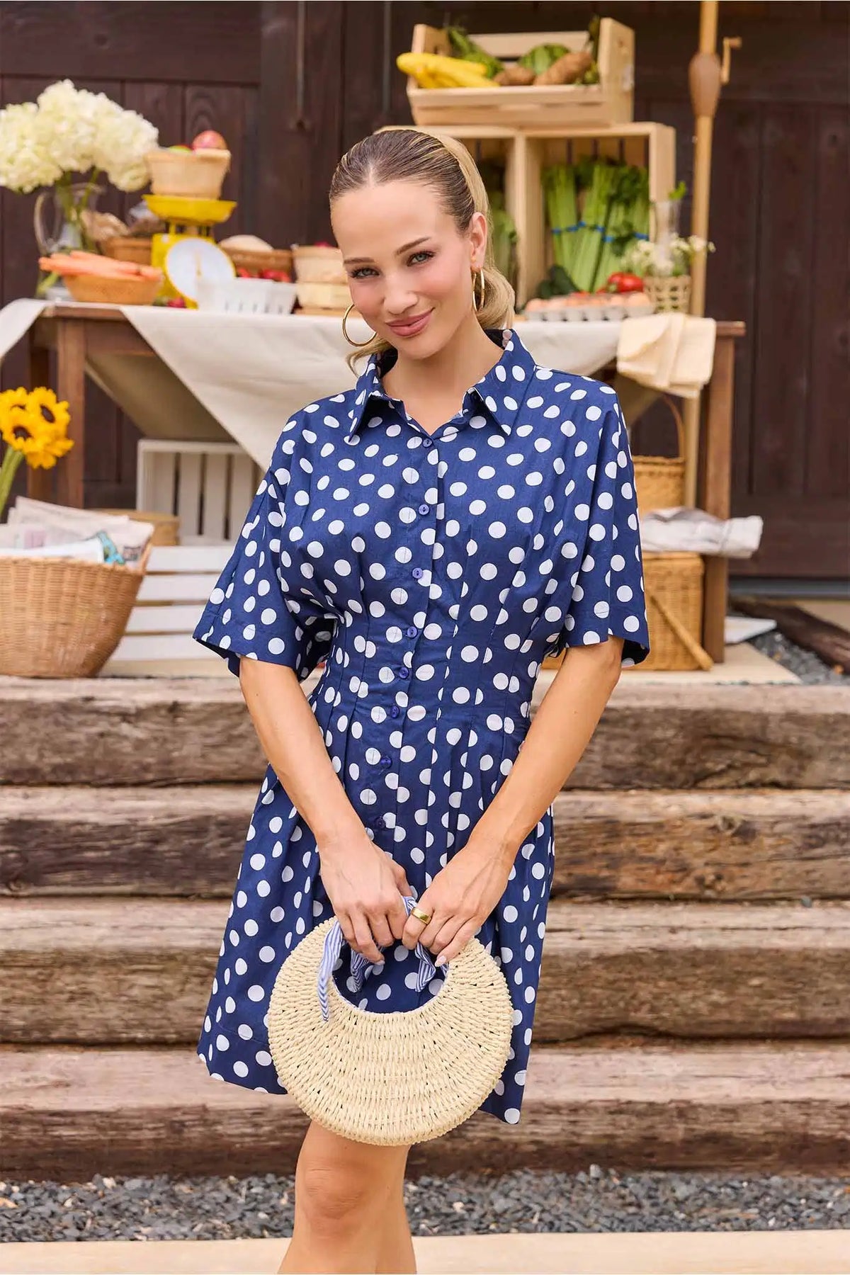 Addison Navy Polka Dot Short Dress styled with straw bag at outdoor market - Lifestyle Look | Avara
