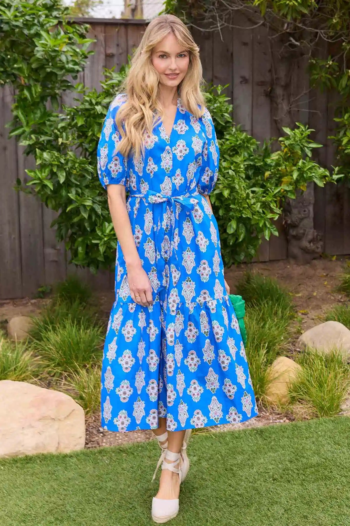 Anita Blue Floral Midi Dress styled outdoors with espadrilles and green bag, garden lifestyle look | Avara