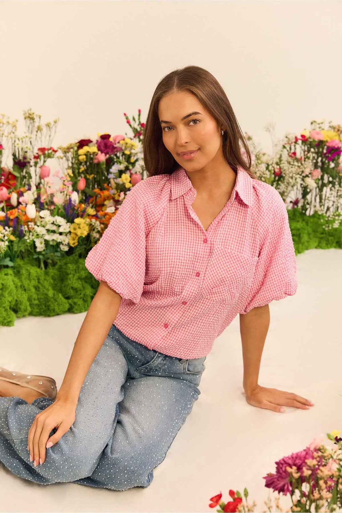 Ashton Pink Gingham Short Sleeve Top styled with denim in floral lifestyle setting | Avara