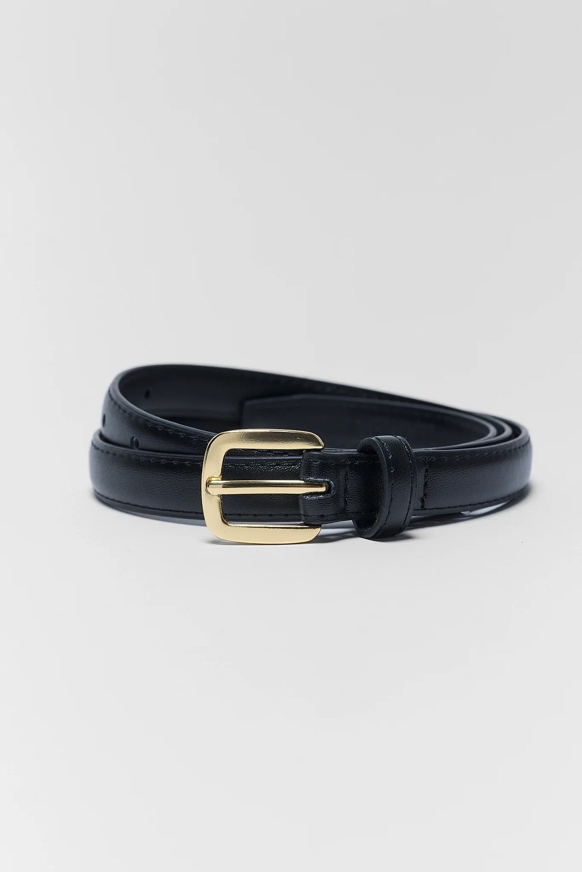 Black faux leather buckle belt coiled, gold-tone hardware detail - Close-Up View | Avara
