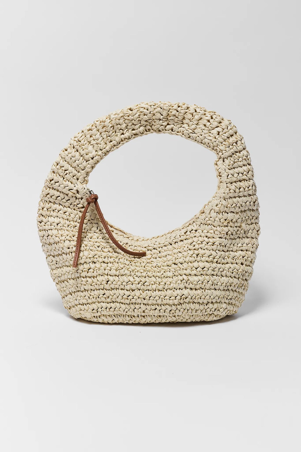 Woven straw handbag with a brown handle on a light gray background