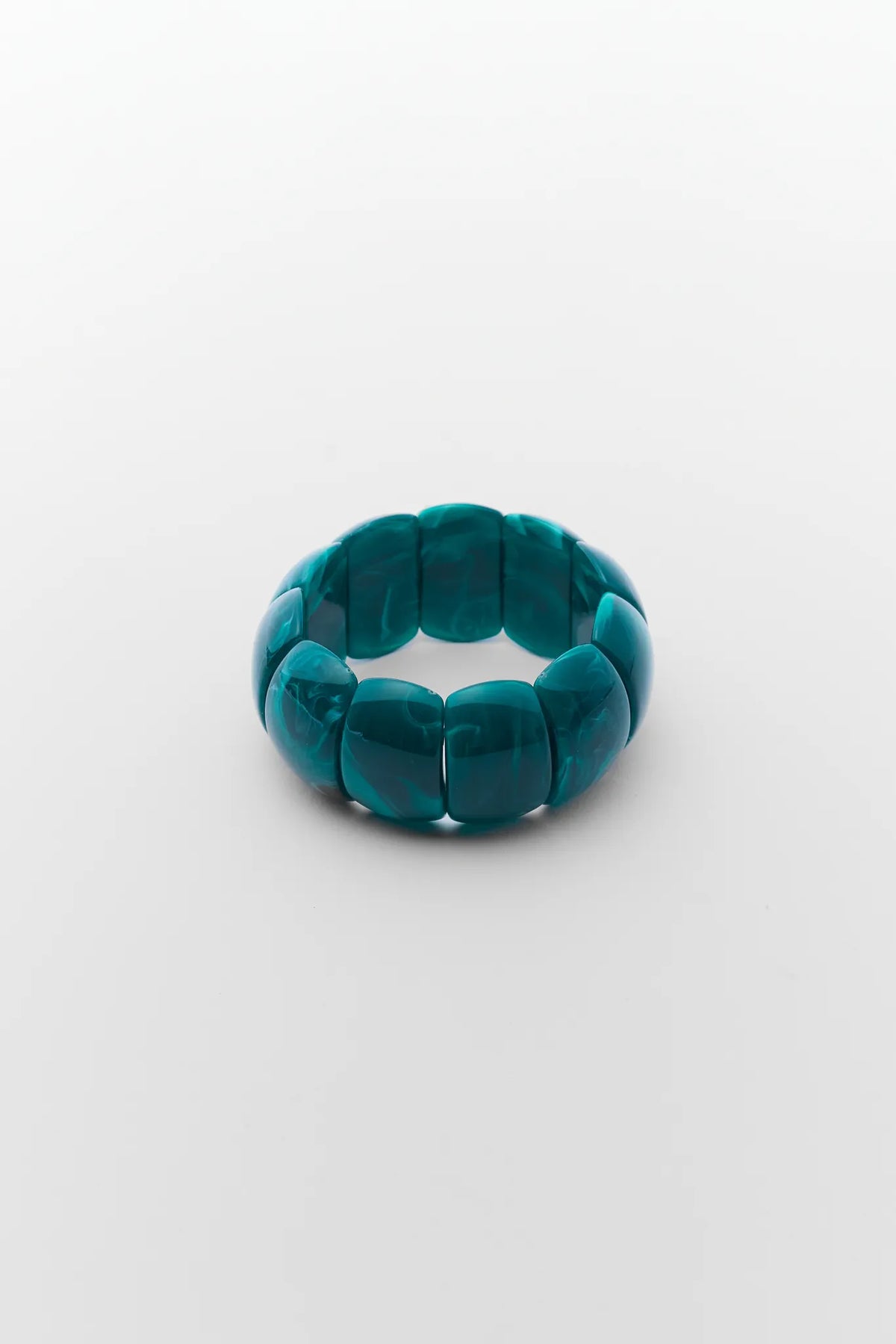 Teal rubber band on a white background