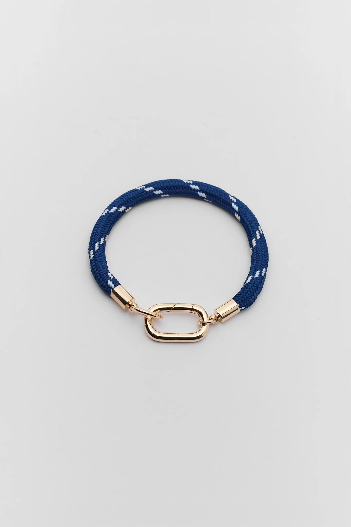 Navy blue braided cord carabiner bracelet with gold-toned clasp - Flat Lay | Avara