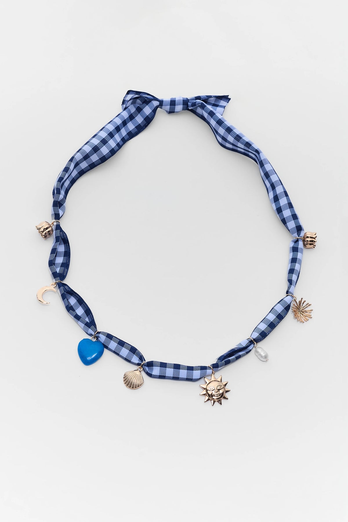 Blue gingham scarf necklace with gold sun, shell, heart, and moon charms - Flat Lay | Avara