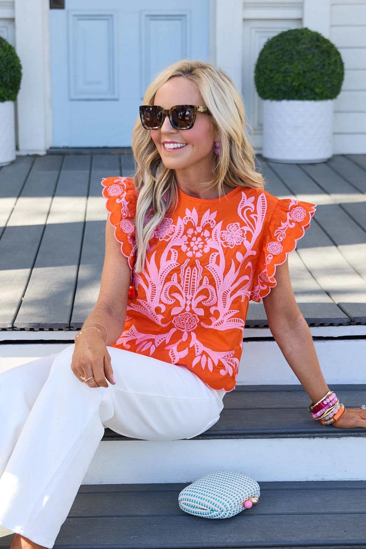 Bradley Orange Embroidered Top by THML styled with white pants outdoors - Lifestyle Look | Avara