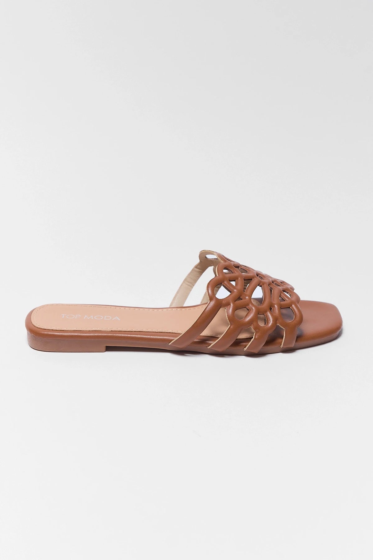 Brown cutout floral sandal - side profile showing flat sole and open-toe design | Avara