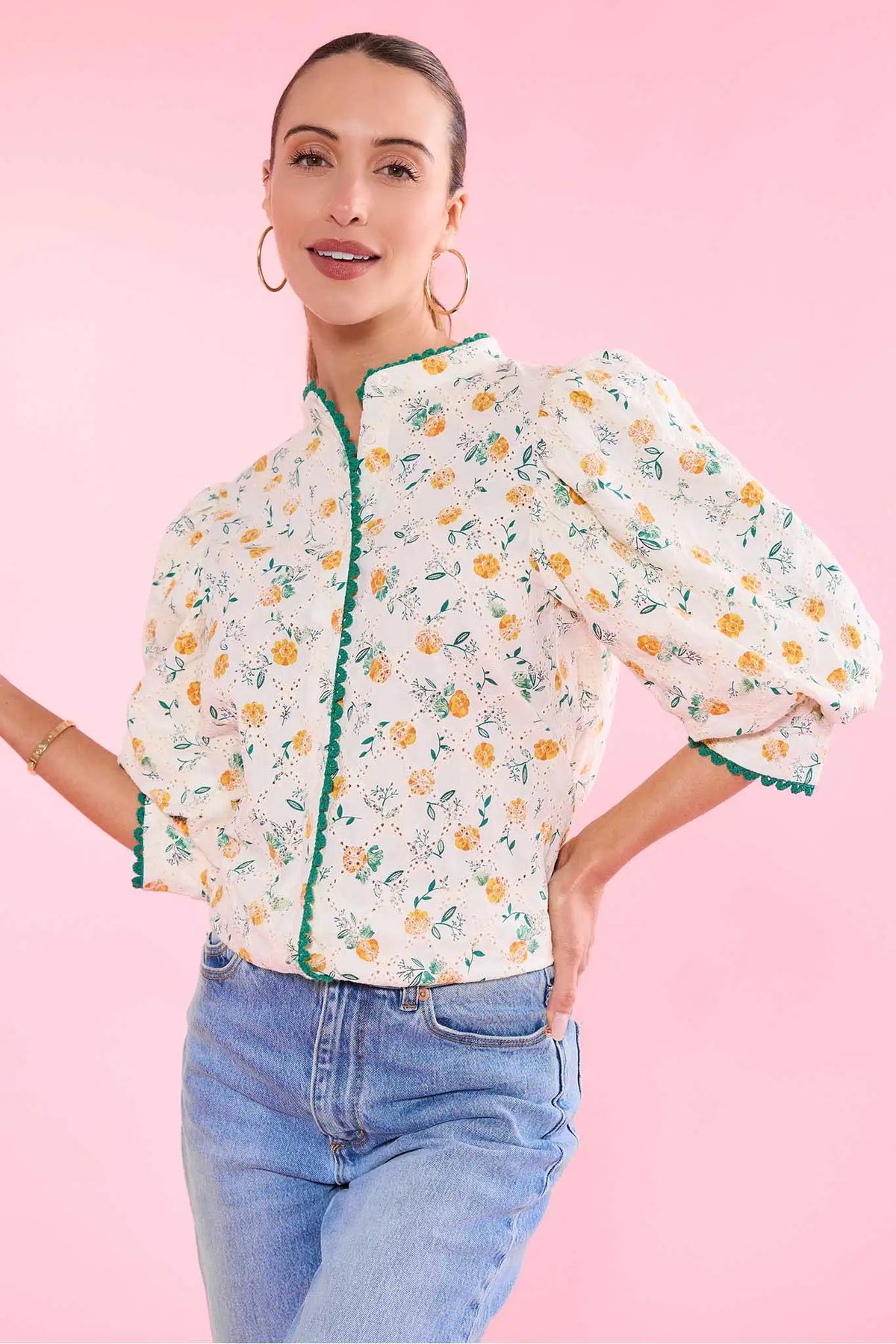 Cece Ivory Floral Eyelet Top styled with jeans on pink background - Front Angle | Avara