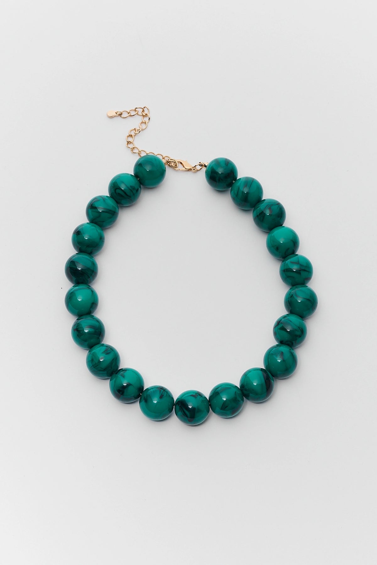 Green chunky beaded necklace with marbled beads and gold-tone lobster clasp extender - Flat Lay | Avara