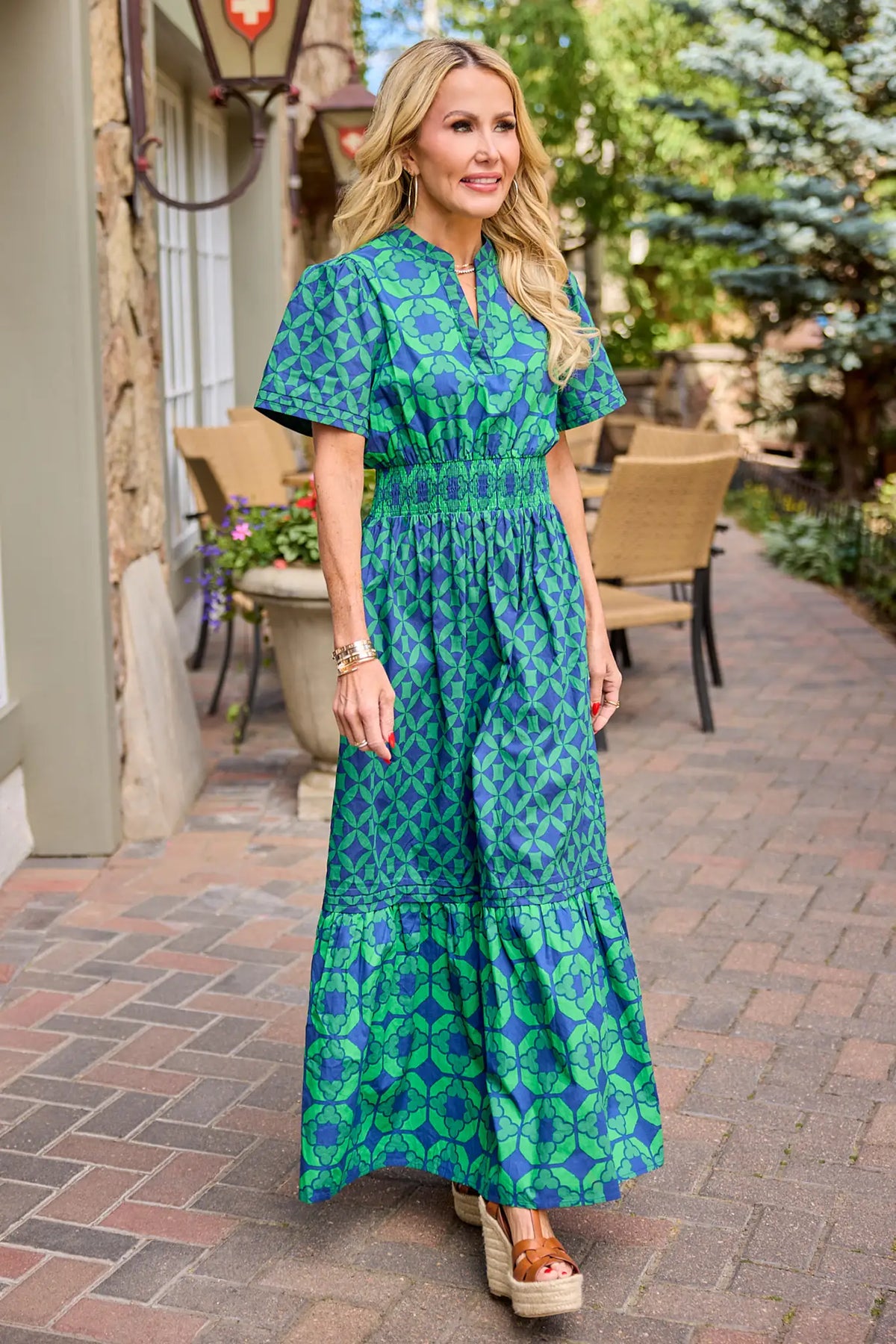 Isabella Green Navy Geometric Print Modest Maxi Dress, smocked waist, short sleeves, styled with wedges - On Model Outdoor | Avara