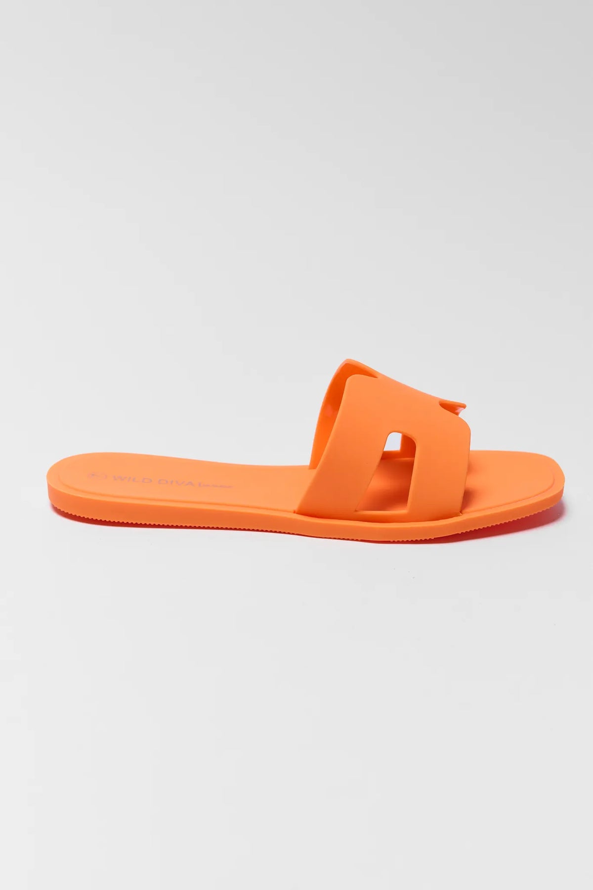 Orange slip-on jelly sandal with matte finish and flat sole, side profile | Avara