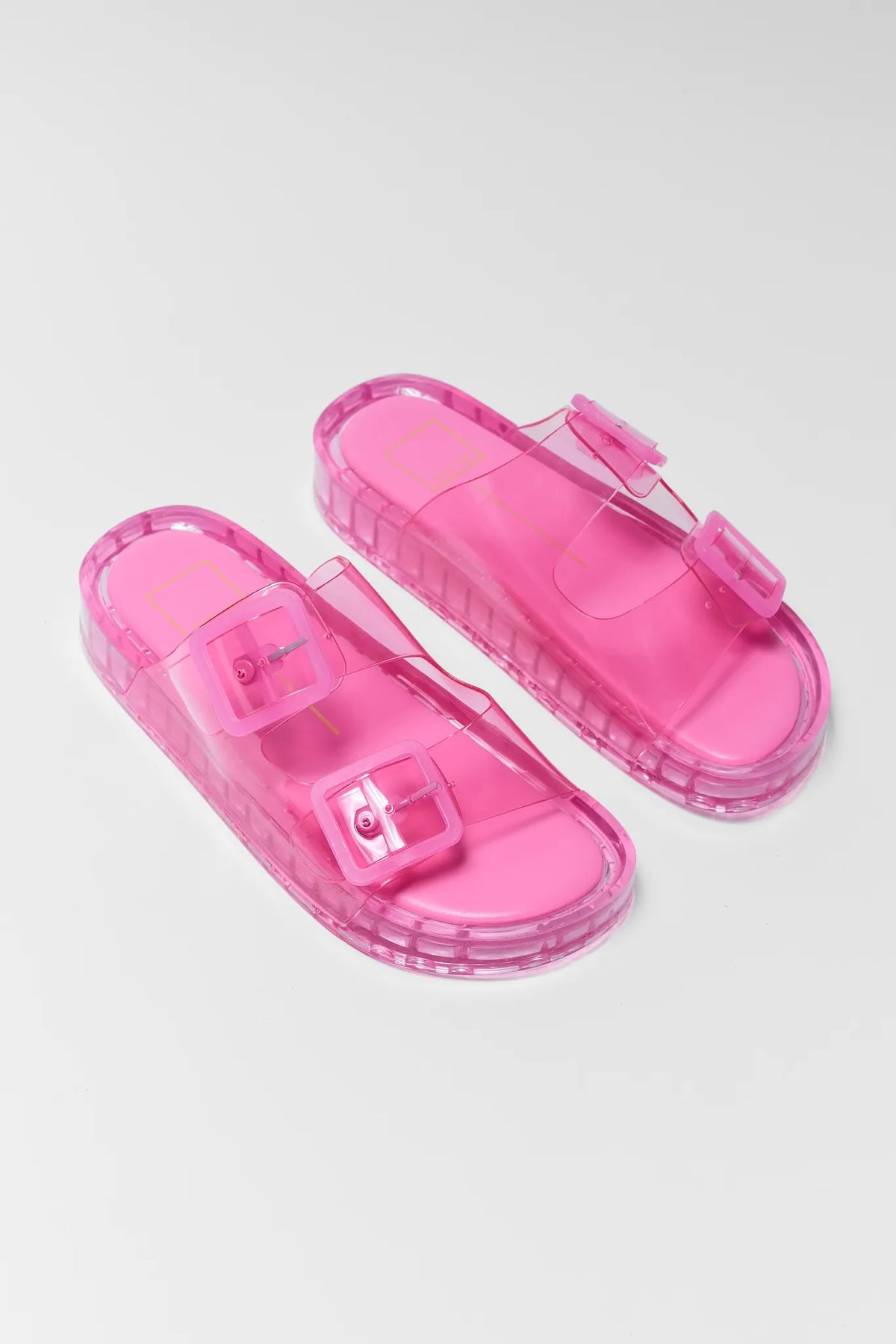 Hot pink transparent jelly sandals with square buckles and chunky sole - Angled Pair View | Avara
