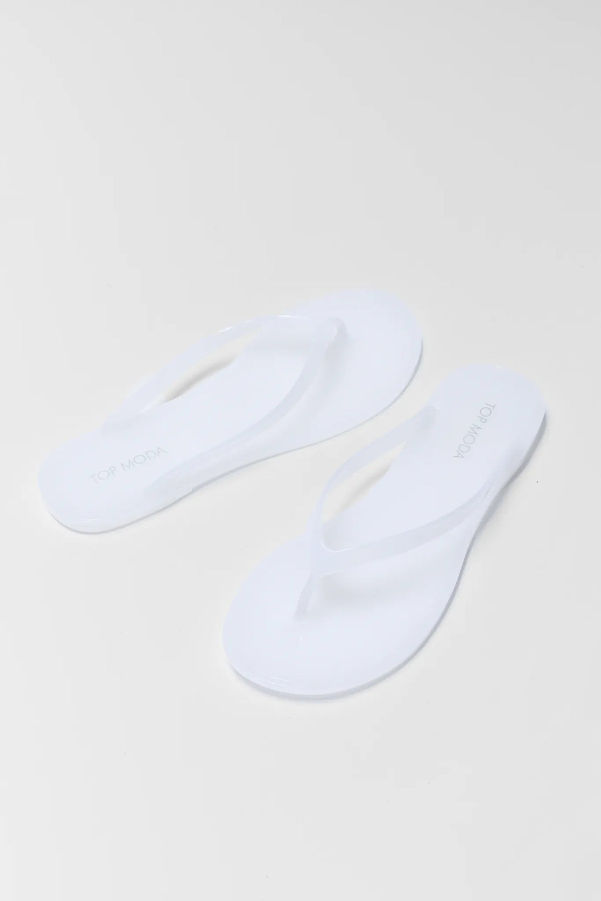 Kathy White Jelly Flip Flop Sandals - Angled Pair View | Avara