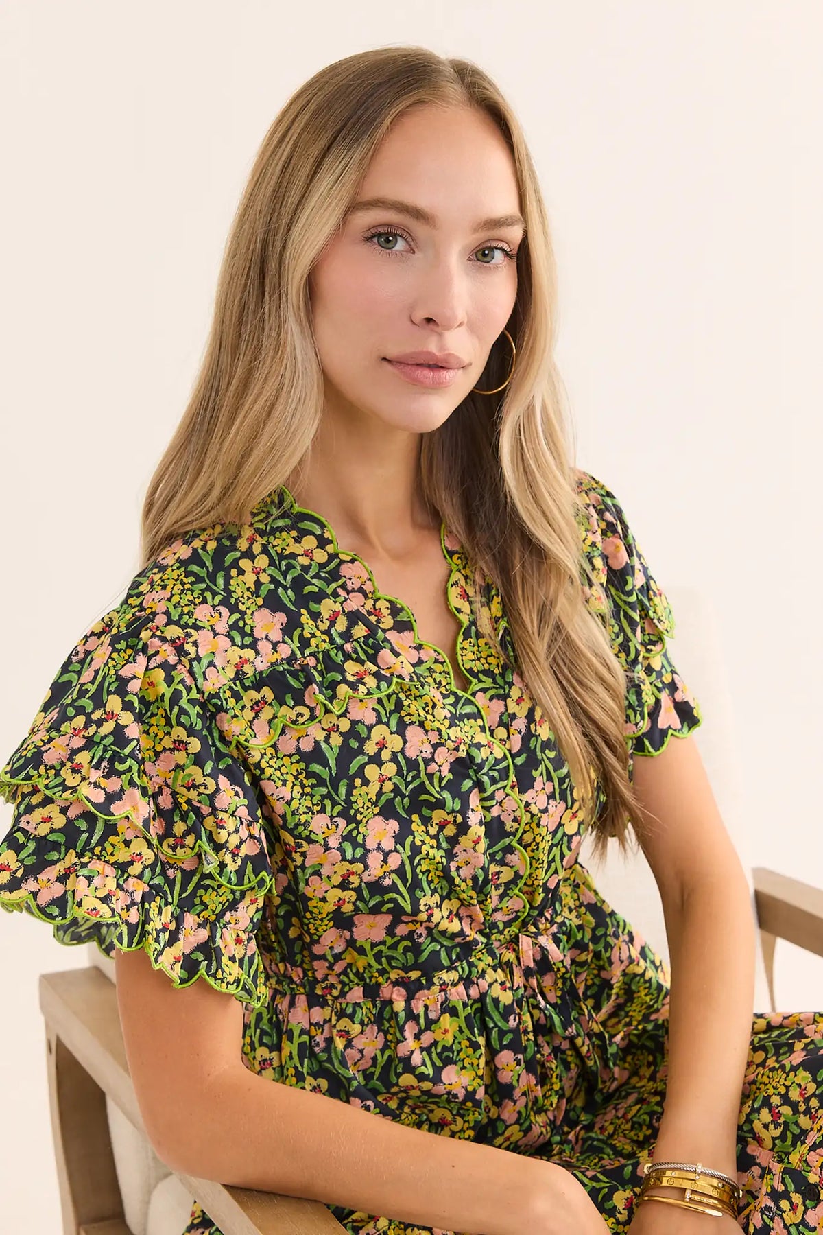 Carly Multi Printed Maxi Dress close-up showing scalloped V-neckline and flutter sleeves with green trim | Avara