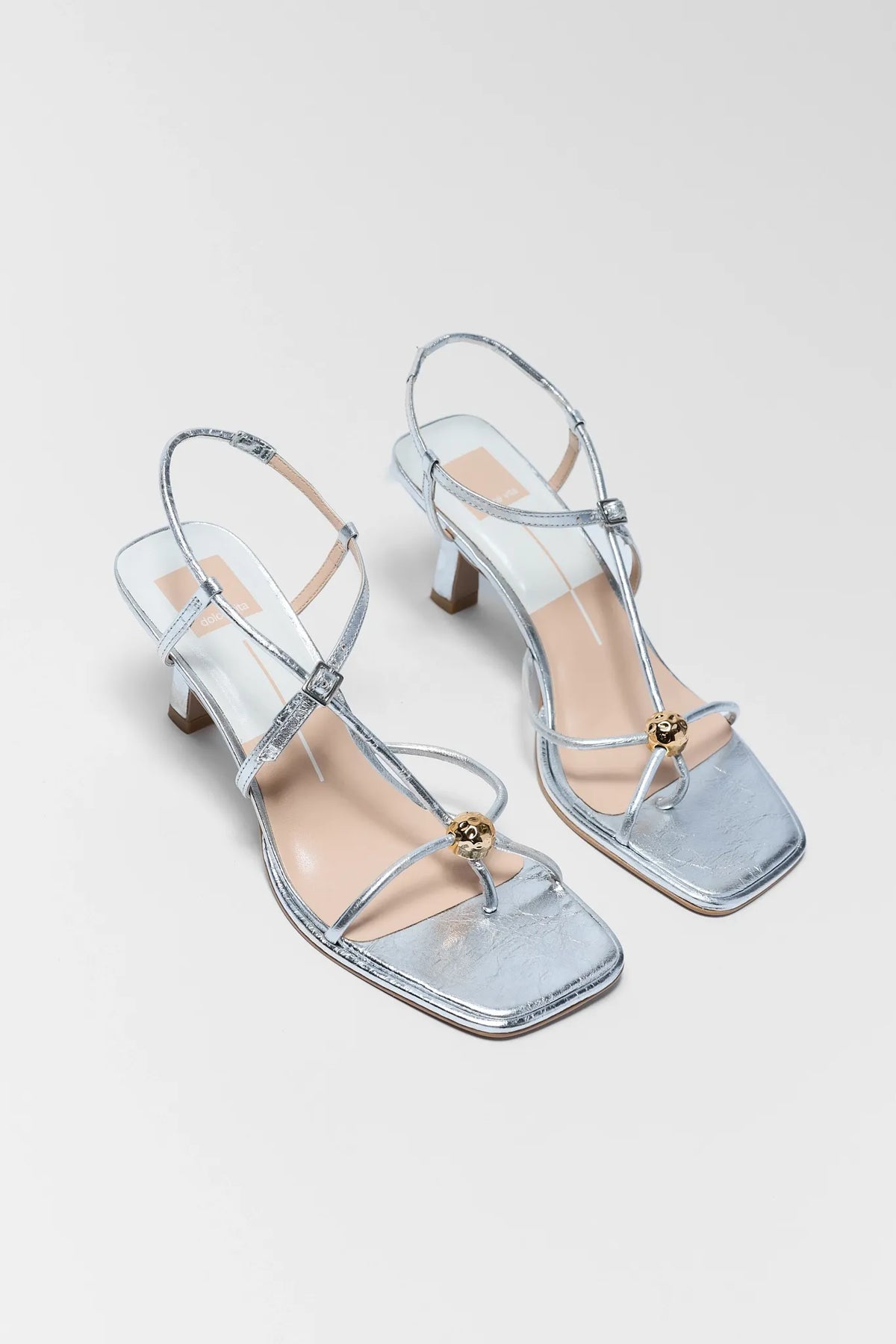 Mylee Silver Strappy Kitten Heels by Dolce Vita - Angled Pair View Showing Kitten Heel | Avara