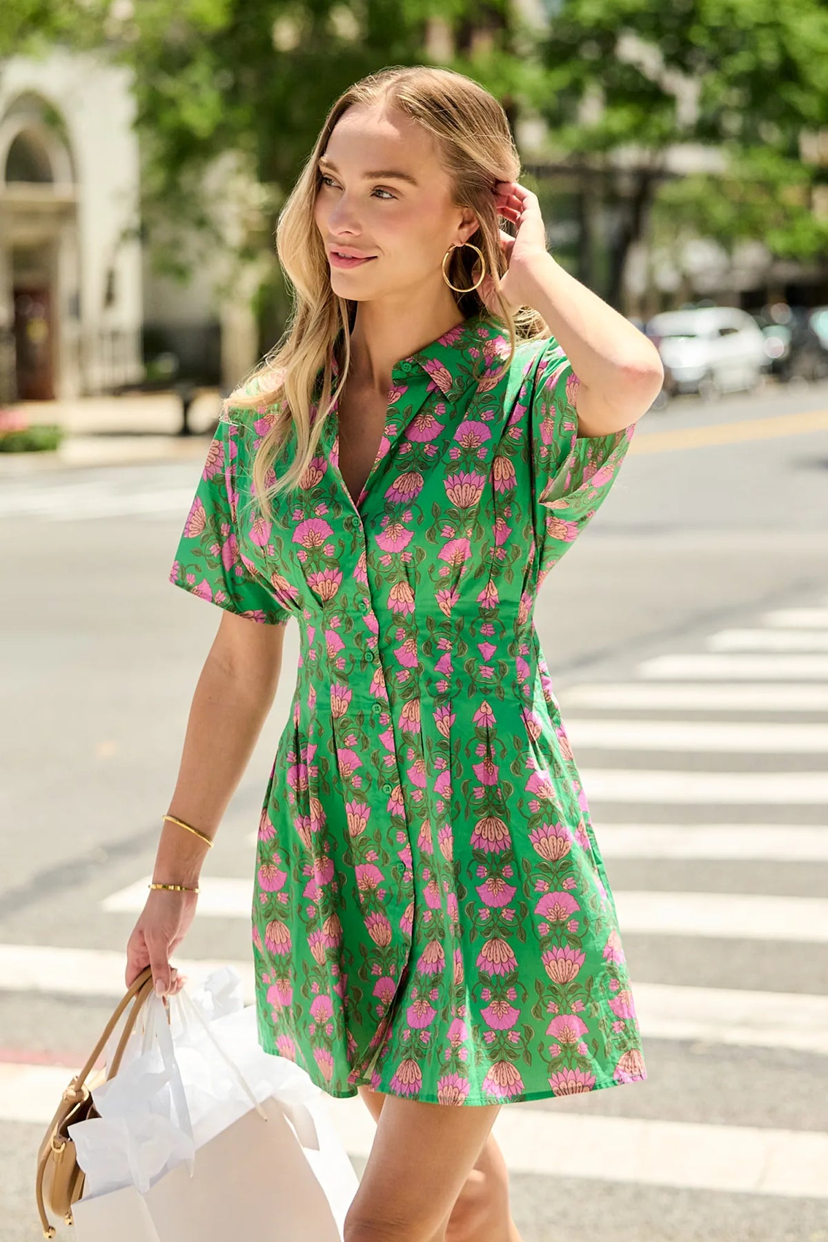 Woman walking city street in Olivia Green Floral Button Up Short Dress - Styled Look | Avara