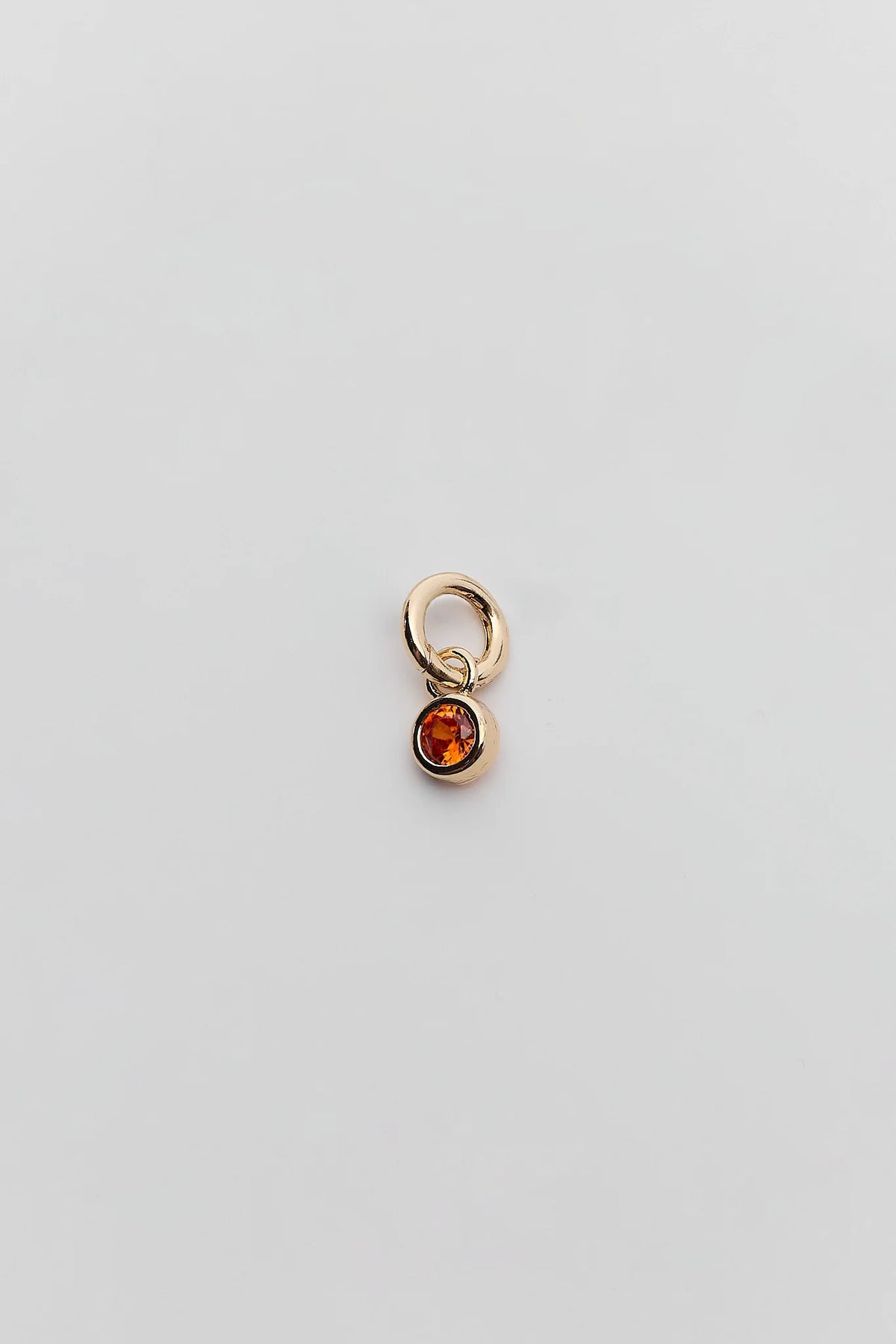 Orange rhinestone gold charm with round bezel setting - Flat Lay Detail | Avara
