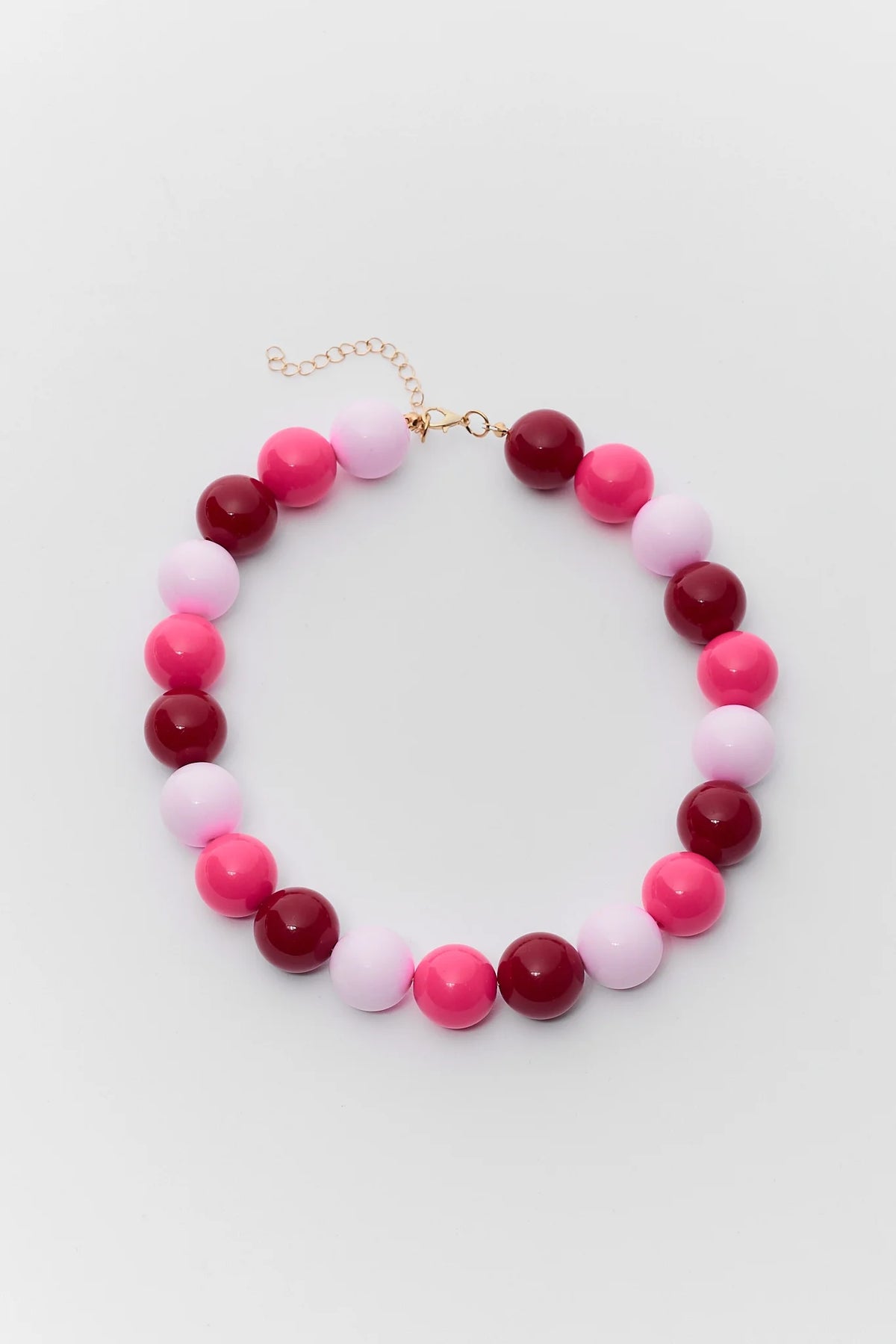 Pink multi chunky beaded necklace with magenta, hot pink, and pale pink round beads and gold-tone lobster clasp - Flat Lay | Avara