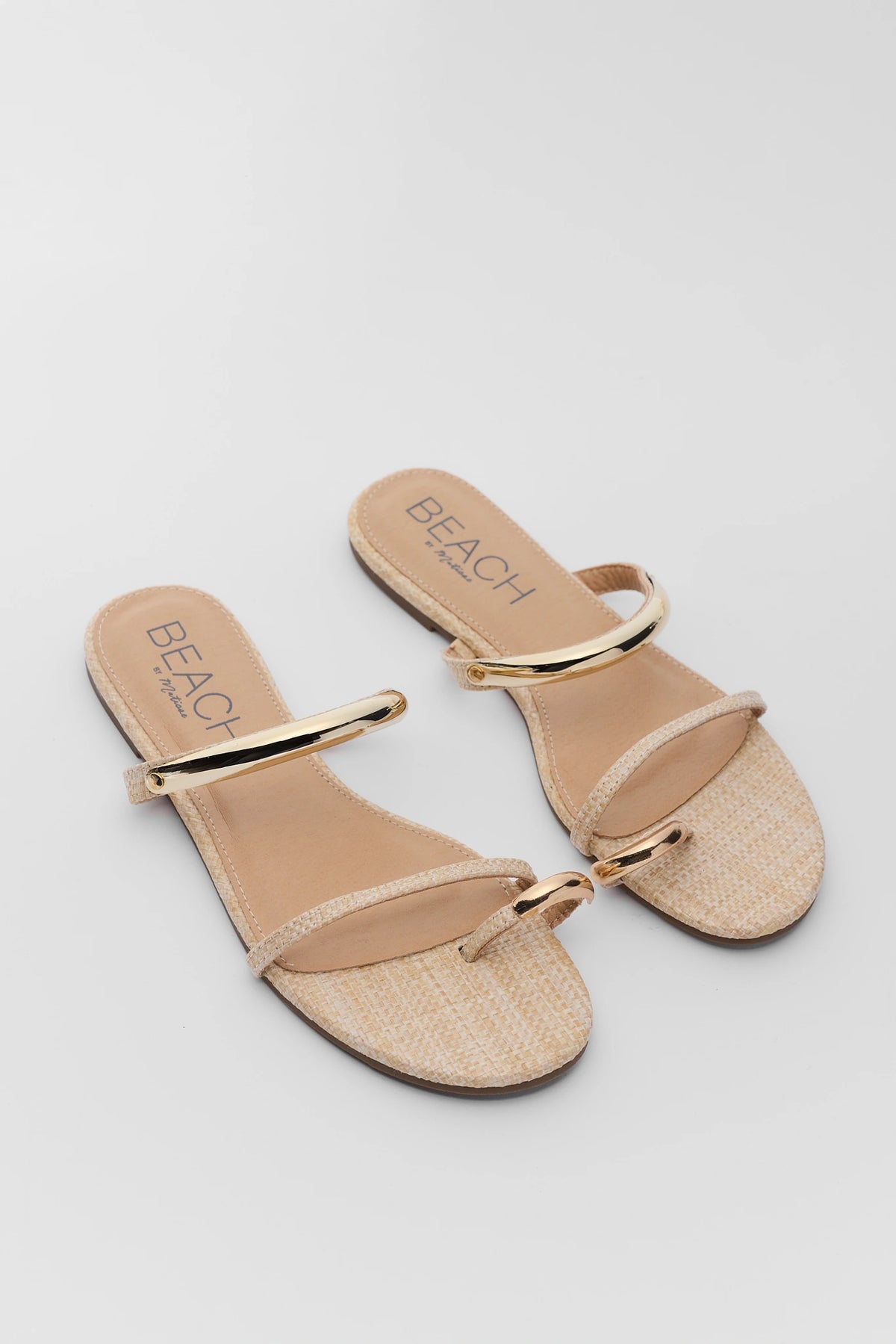 Natural raffia gold detail sandals pair, angled flat lay showing woven texture and gold accents | Avara