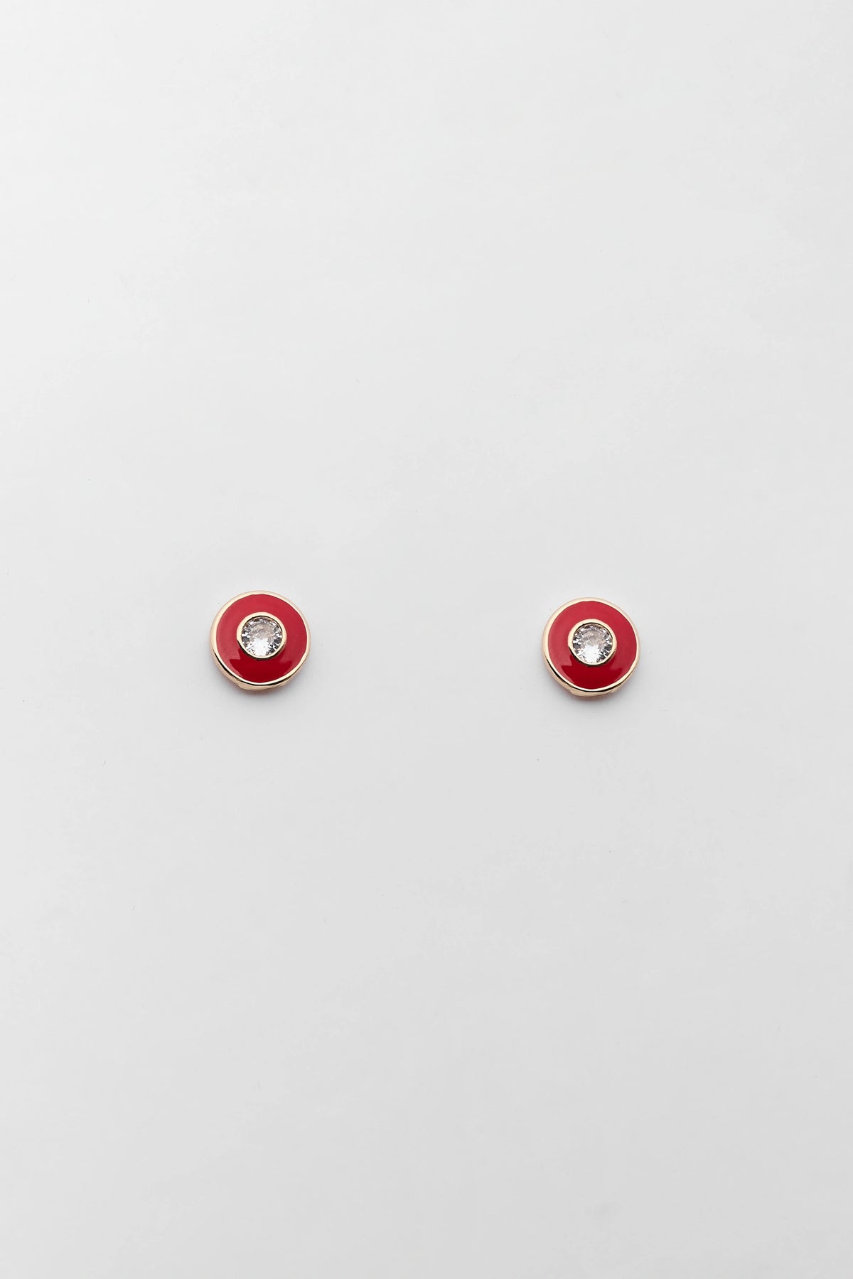 Red Enamel Rhinestone Stud Earrings with gold-tone rim and clear crystal center - Flat Lay | Avara