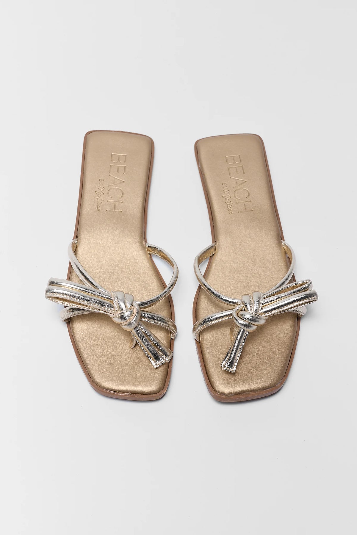 Gold metallic knot sandals top-down view showing knotted strap detail - Ruthie by Matisse | Avara