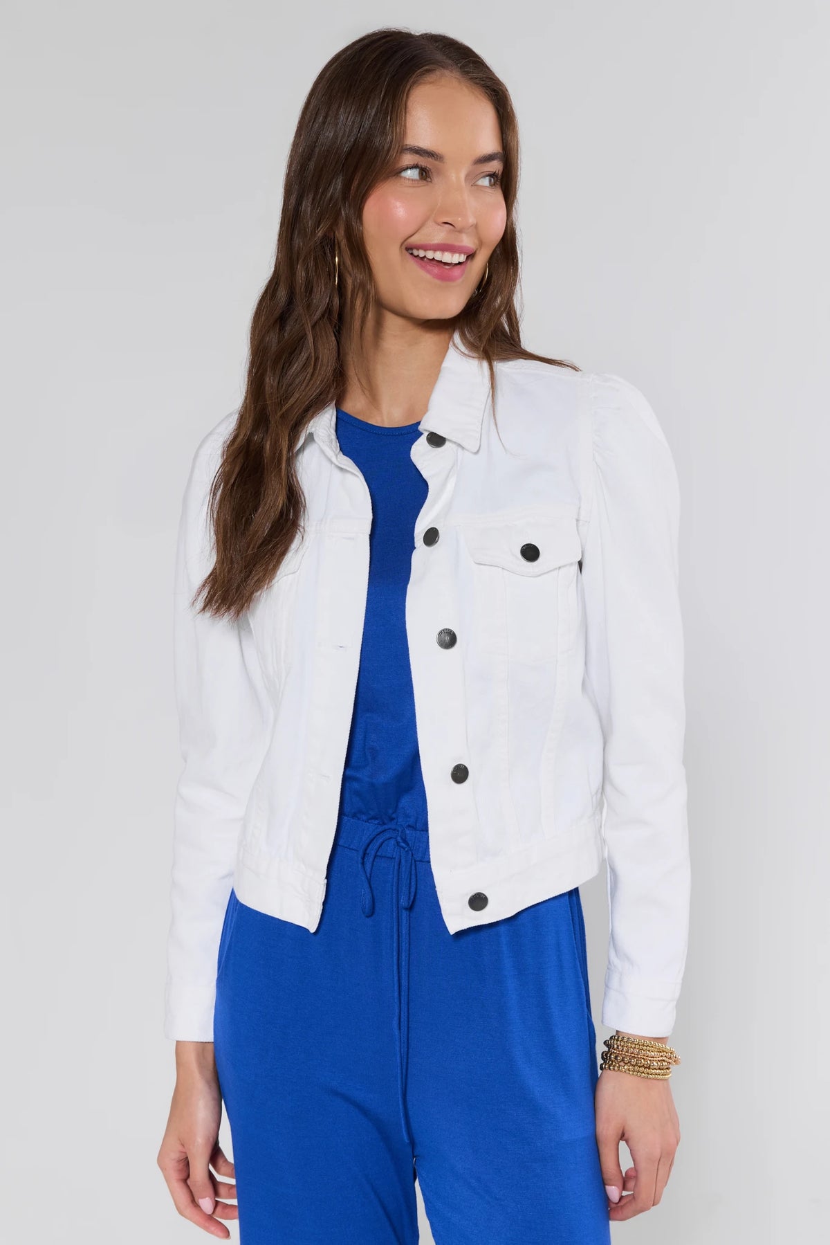 Roxanna White Denim Jacket open front view with puff sleeves over royal blue wide-leg jumpsuit - On Model | Avara