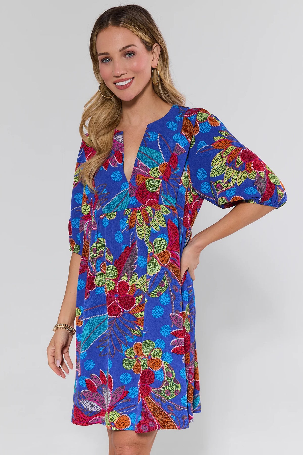 Rita Blue Floral Print Short Dress, 3/4 front view, bold multicolor print, balloon sleeves | Avara