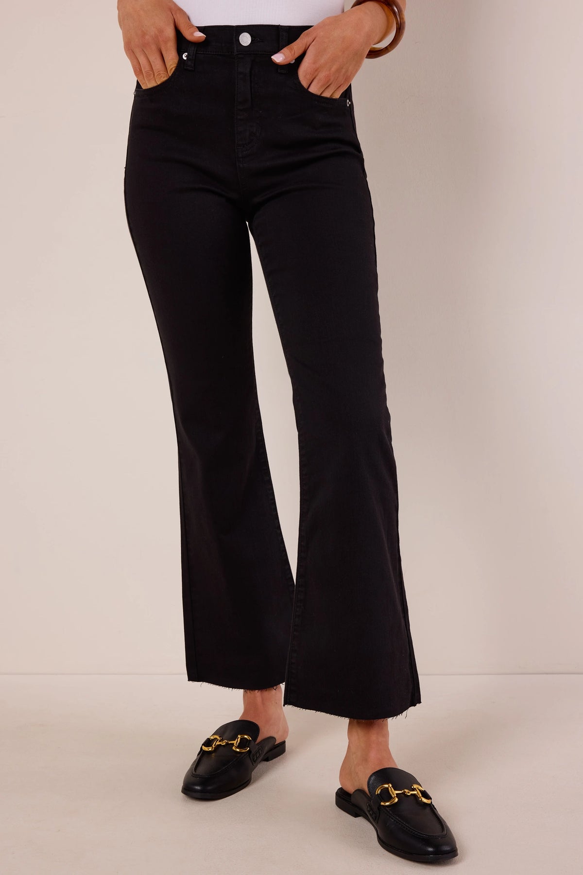 Heather Black Kick Flare Jeans with raw hem, high-rise fit, hands in pockets, styled with black horsebit mules | Avara
