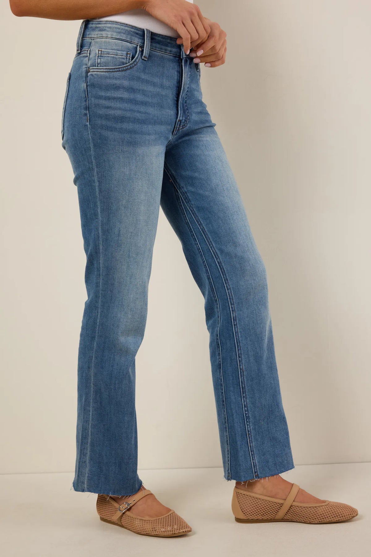 Kelsey Light Wash Kick Flare Jeans by KUT - Side Profile showing inset panel flare and raw hem detail | Avara