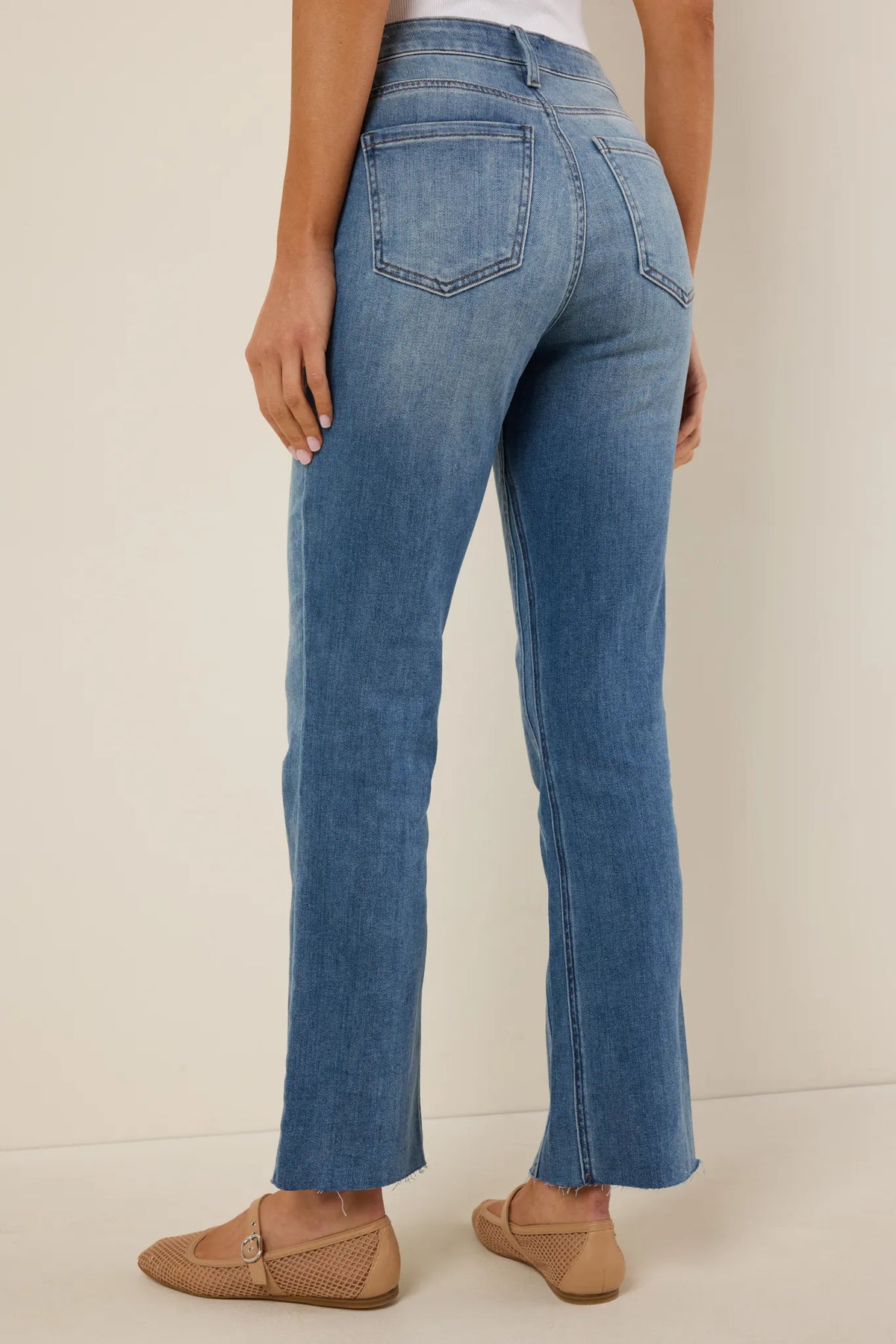 Kelsey Light Wash Kick Flare Jeans by KUT - Back View showing high-rise waist, back pockets, and raw hem | Avara
