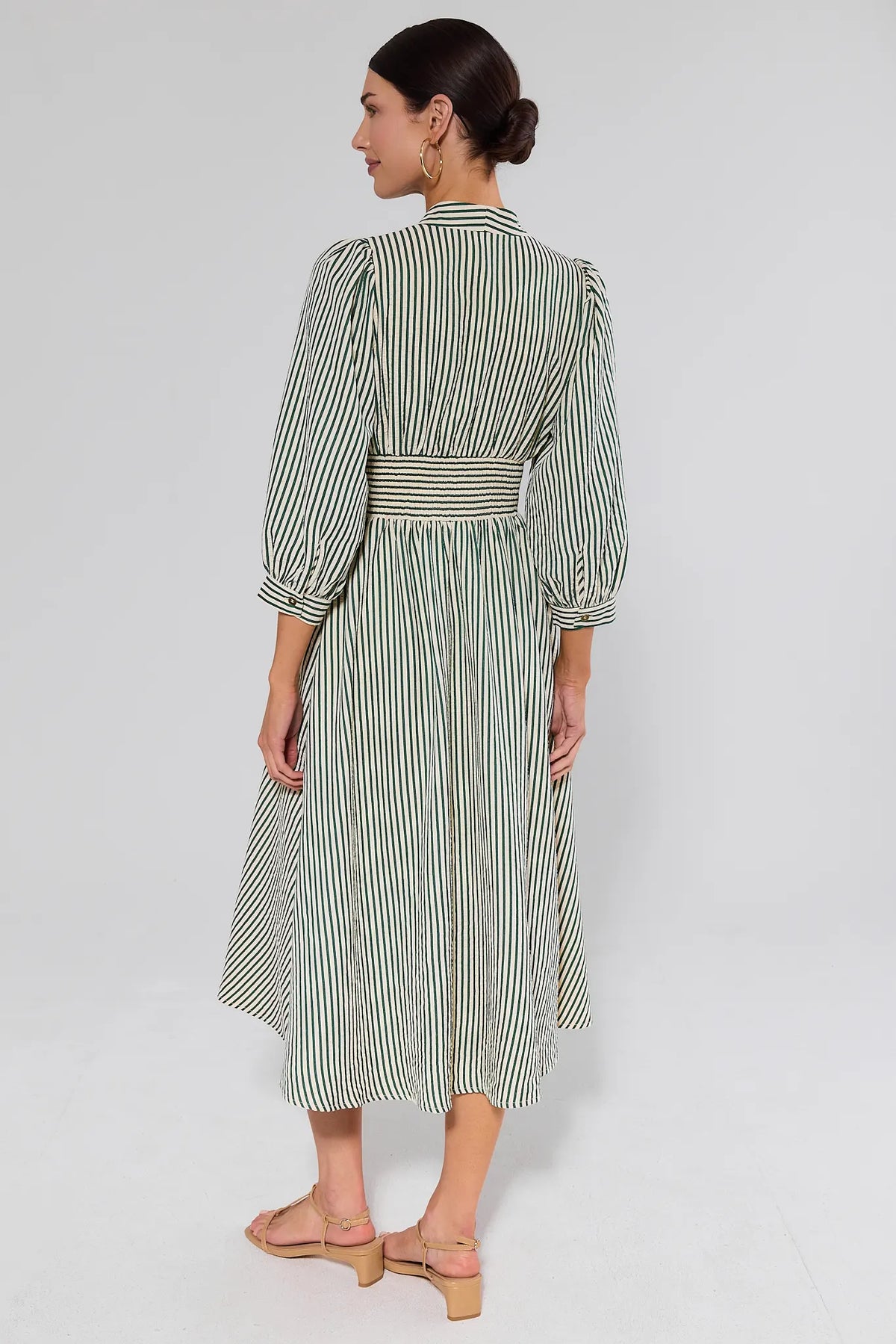Back view of green and white striped Brantley Midi Dress with smocked waist band and puff sleeves | Avara