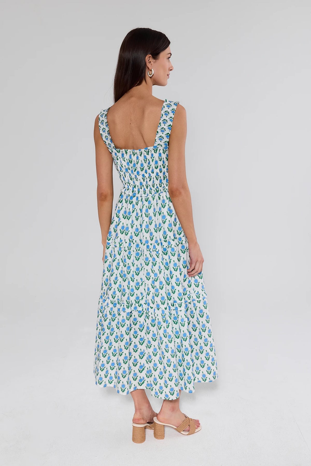 Woman wearing a floral dress on a plain background