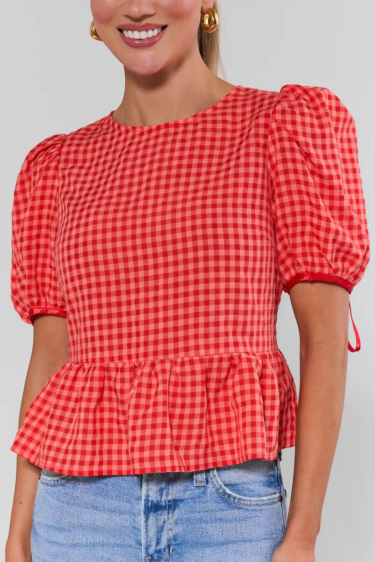Felicia Red Gingham Peplum Top close-up, puff sleeves and peplum hem detail | Avara