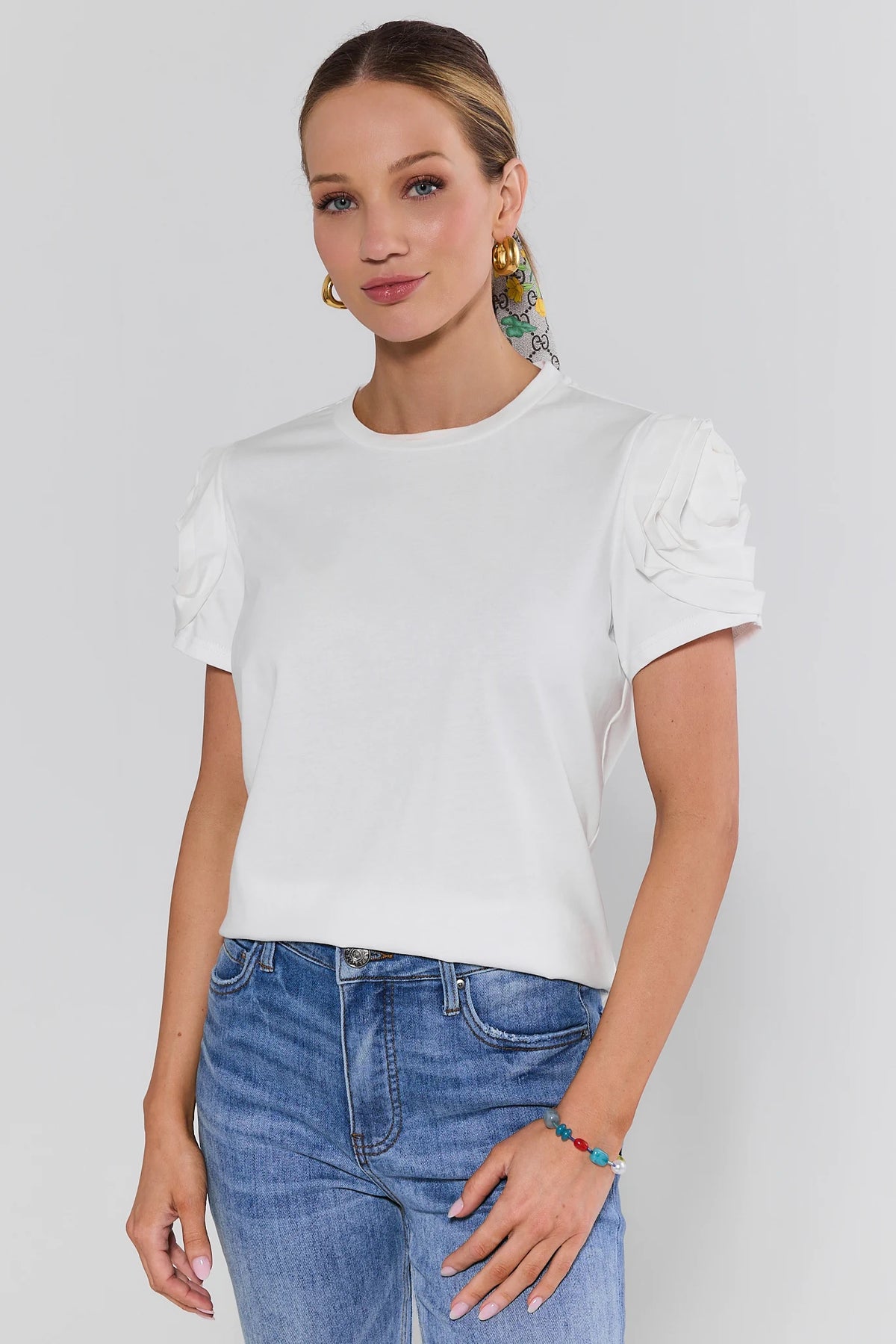 White floral appliqué top with ruched rose sleeves, women's front view on neutral background | Avara