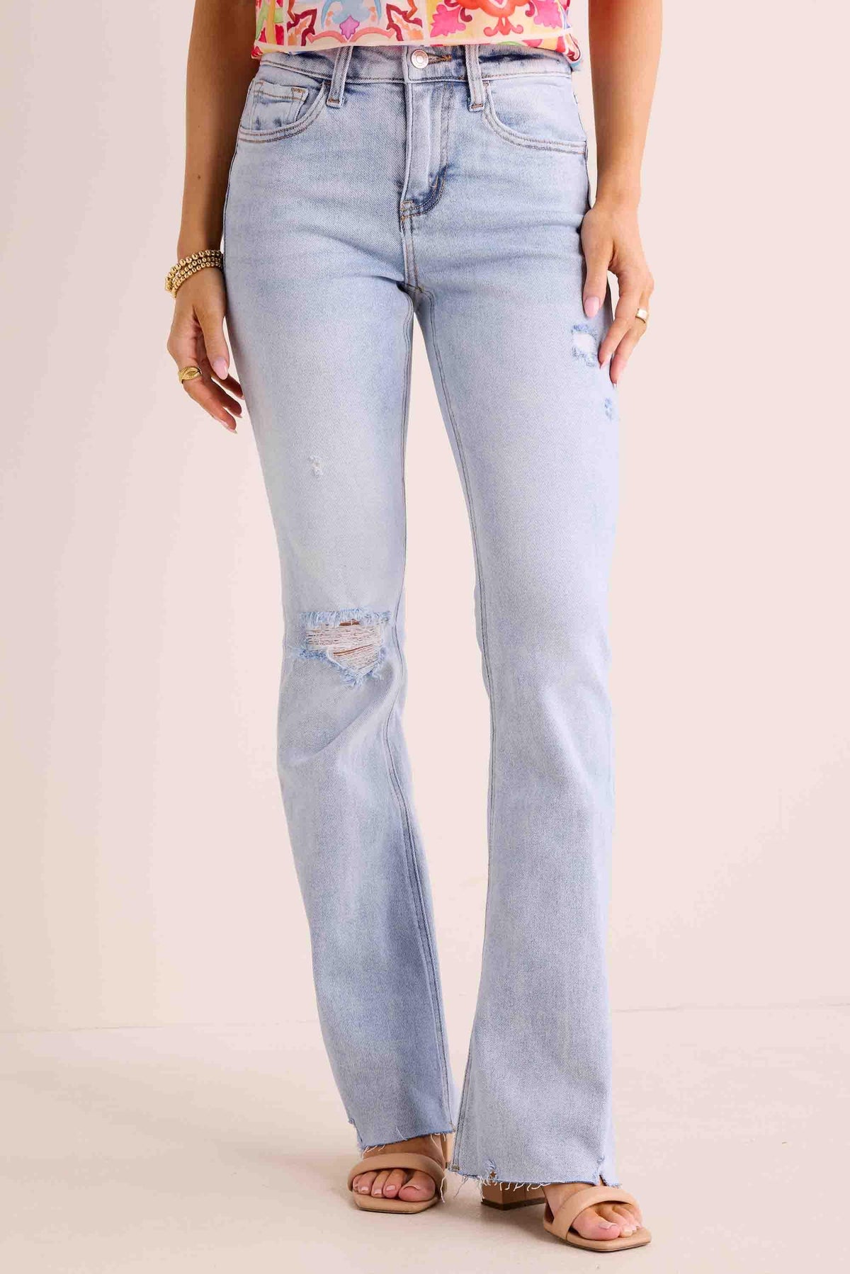 Phoebe Jeans light-wash kick-flare denim with distressed knee and raw hem, front view | Avara