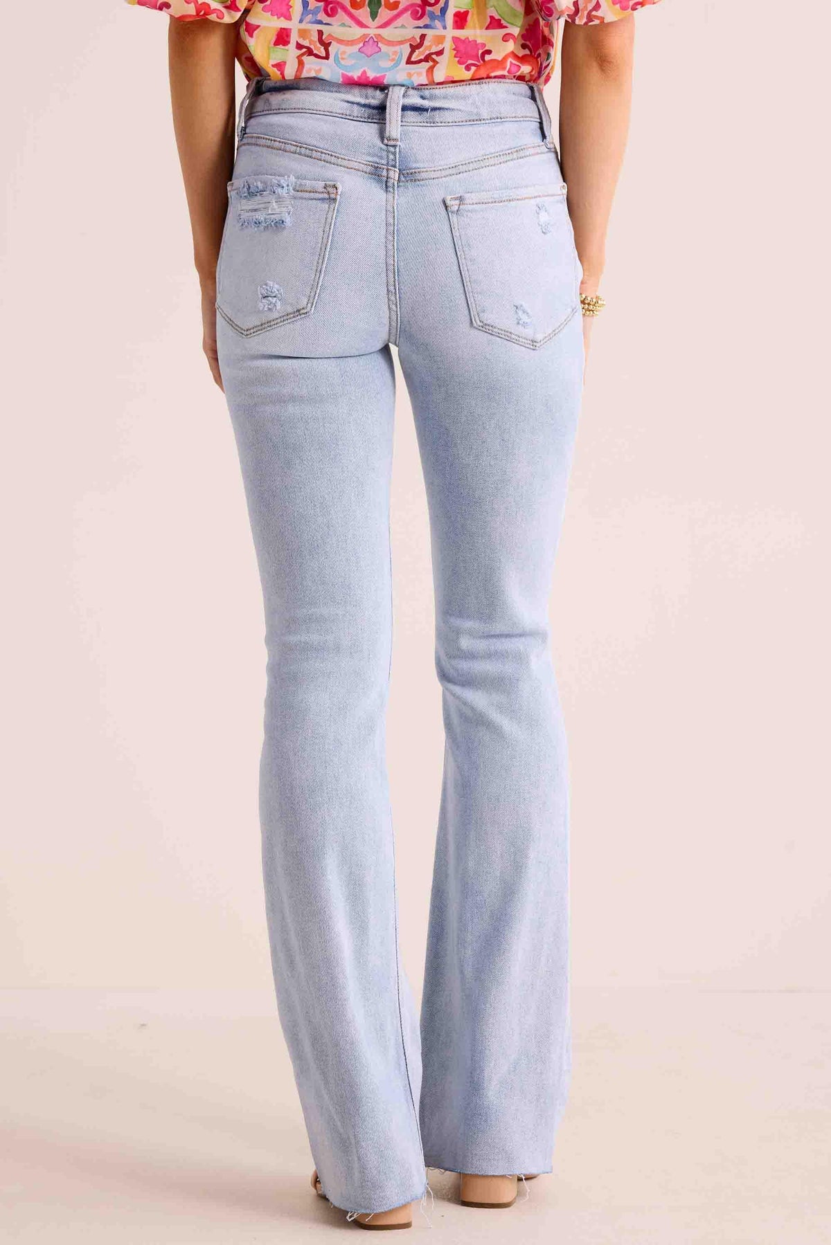 Phoebe Jeans light-wash high-rise kick-flare with distressed back pockets, rear view | Avara