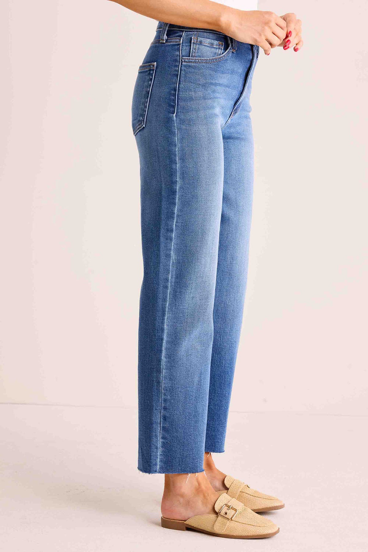 Melanie Medium Wash Straight Leg Jeans back view showing patch pockets, raw hem, and high-rise waist, styled with tan sandals | Avara