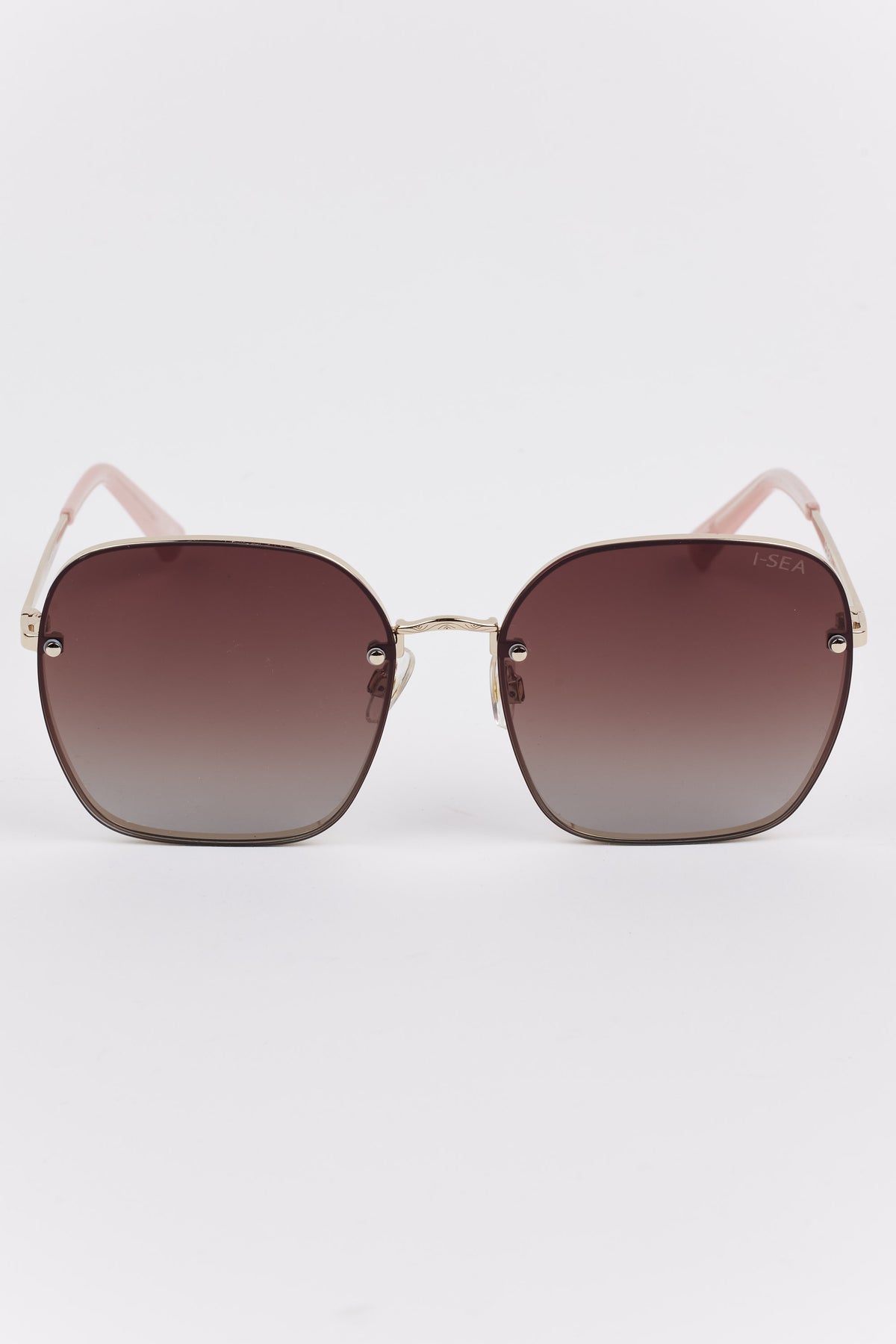 Emerson Round Polarized Sunglasses with oversized hexagonal lenses, brown gradient tint, gold-tone frame, blush-pink temple arms, and subtle I-SEA branding on the right lens.