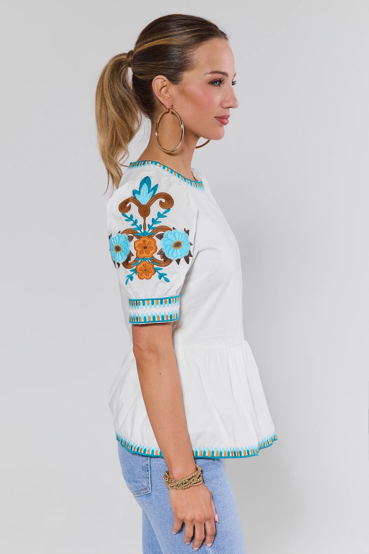 White Embroidered Peplum Top - Side Profile Showing Floral Sleeve Embroidery | Avara