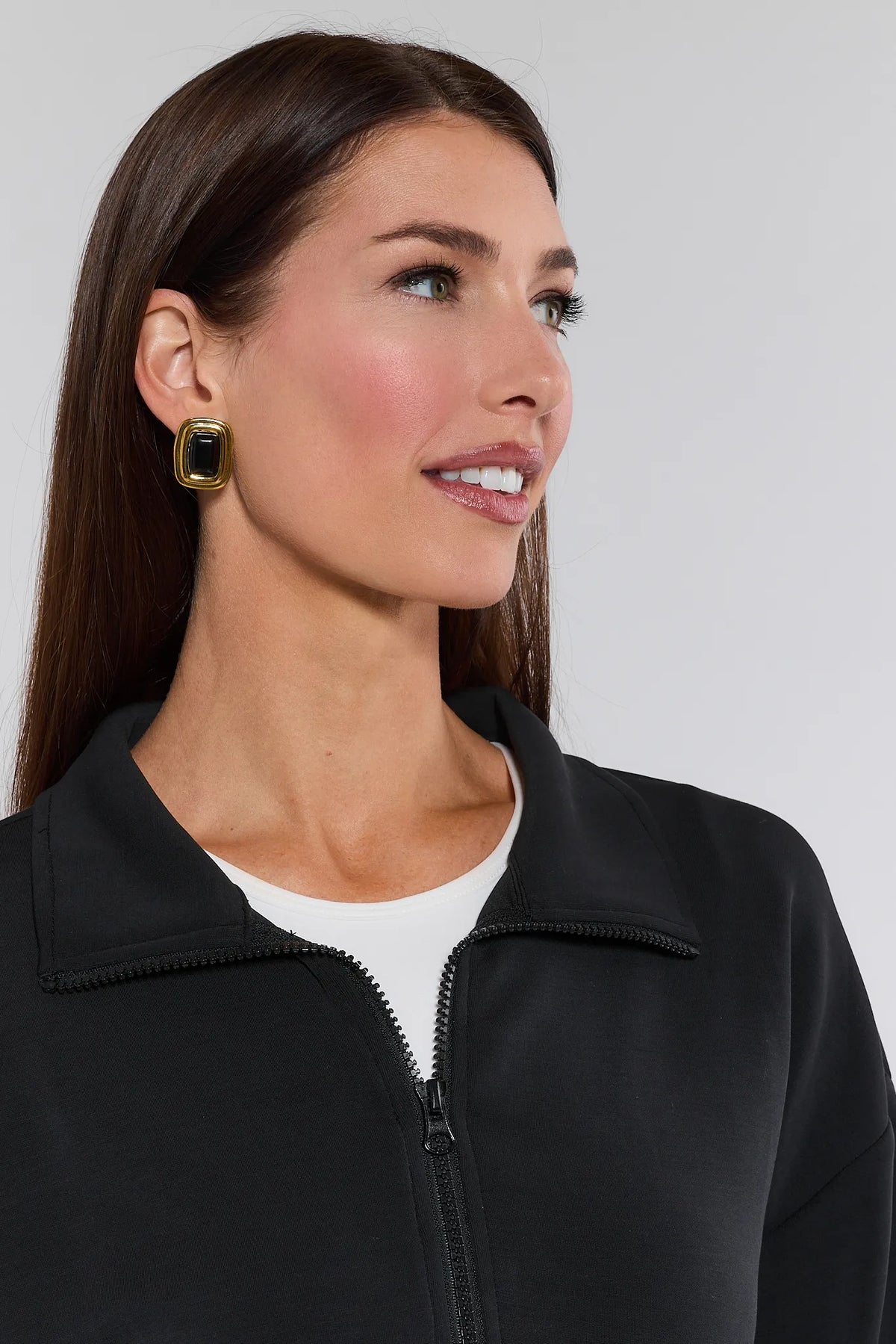 Lucy Black Half Zip Pullover collar and zip detail close-up, gold statement earrings, white tee underneath | Avara