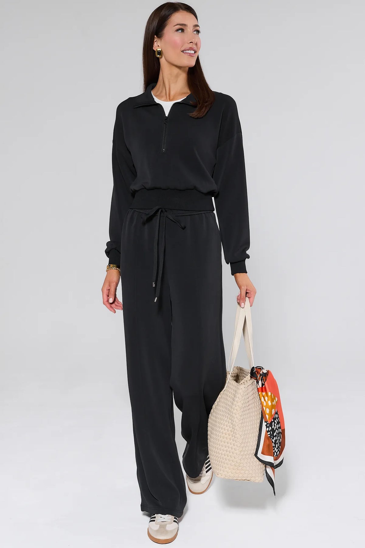 Lucy Black Half Zip Pullover styled with matching wide-leg pants and woven tote, full travel set look | Avara
