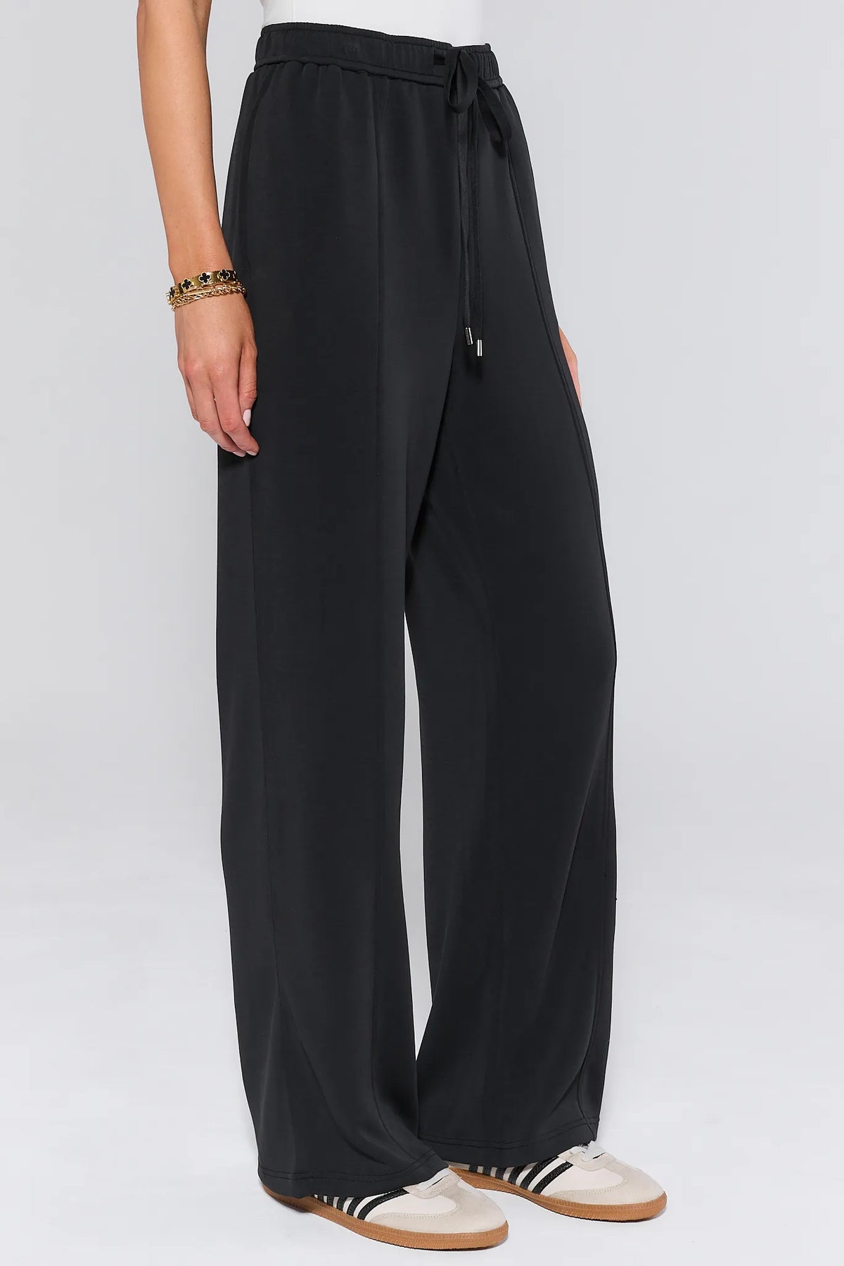 Lucy Black Wide Leg Lounge Pants, side view showing drawstring elastic waist and draped wide-leg silhouette | Avara
