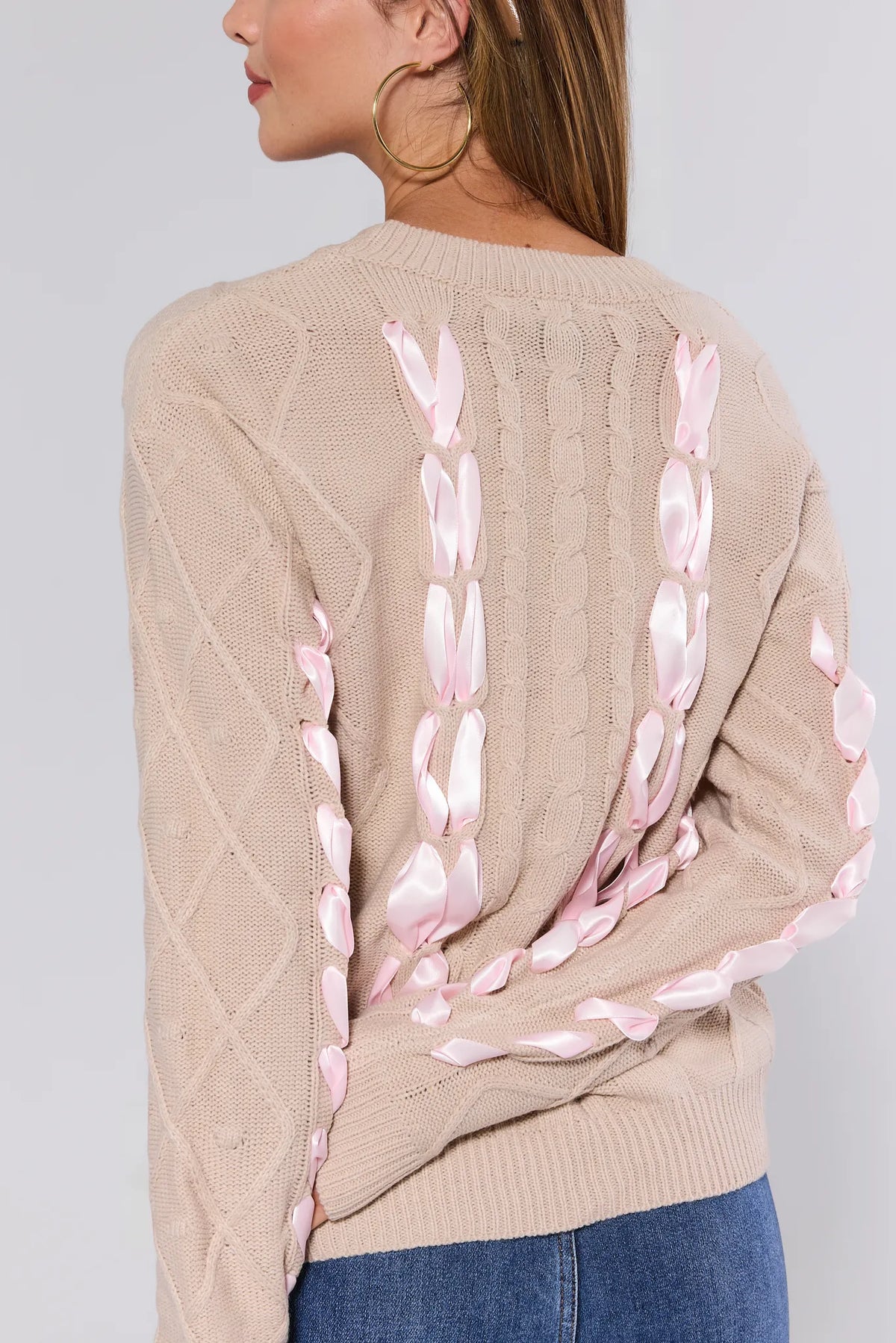 Emerson Cable Knit Bow Sweater in beige, close-up back detail of pink satin ribbon weave and gold hoops | Avara