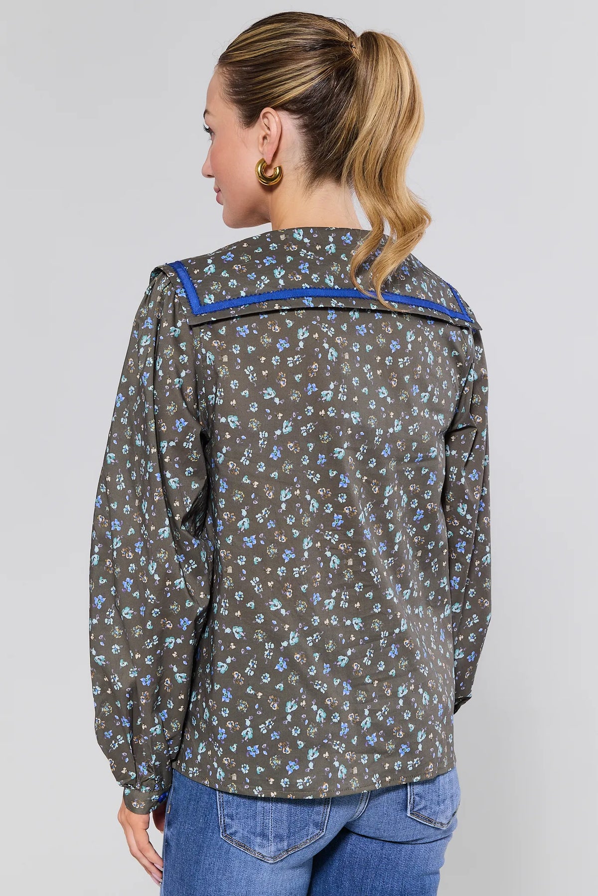 Olive Floral Carol Button Up Top with blue contrast collar trim, on model back view with jeans | Avara