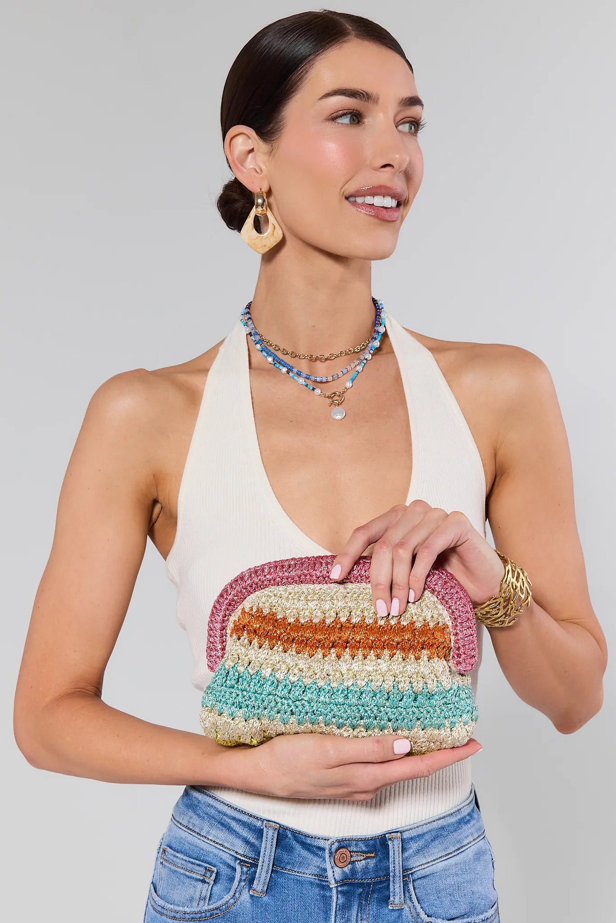 Woman Holding Luna Multicolor Woven Clutch - Front On-Model, Colorful Striped Clutch | Avara