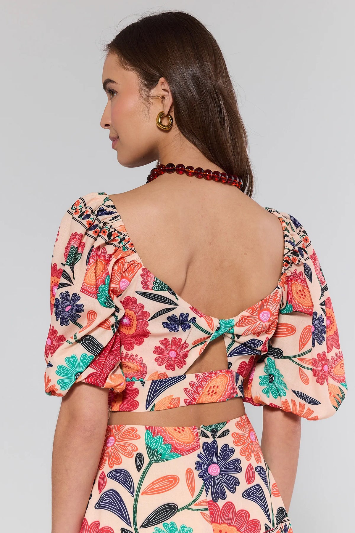 Serena Orange Floral Crop Top - Open Back Detail View with Puff Sleeves | Avara