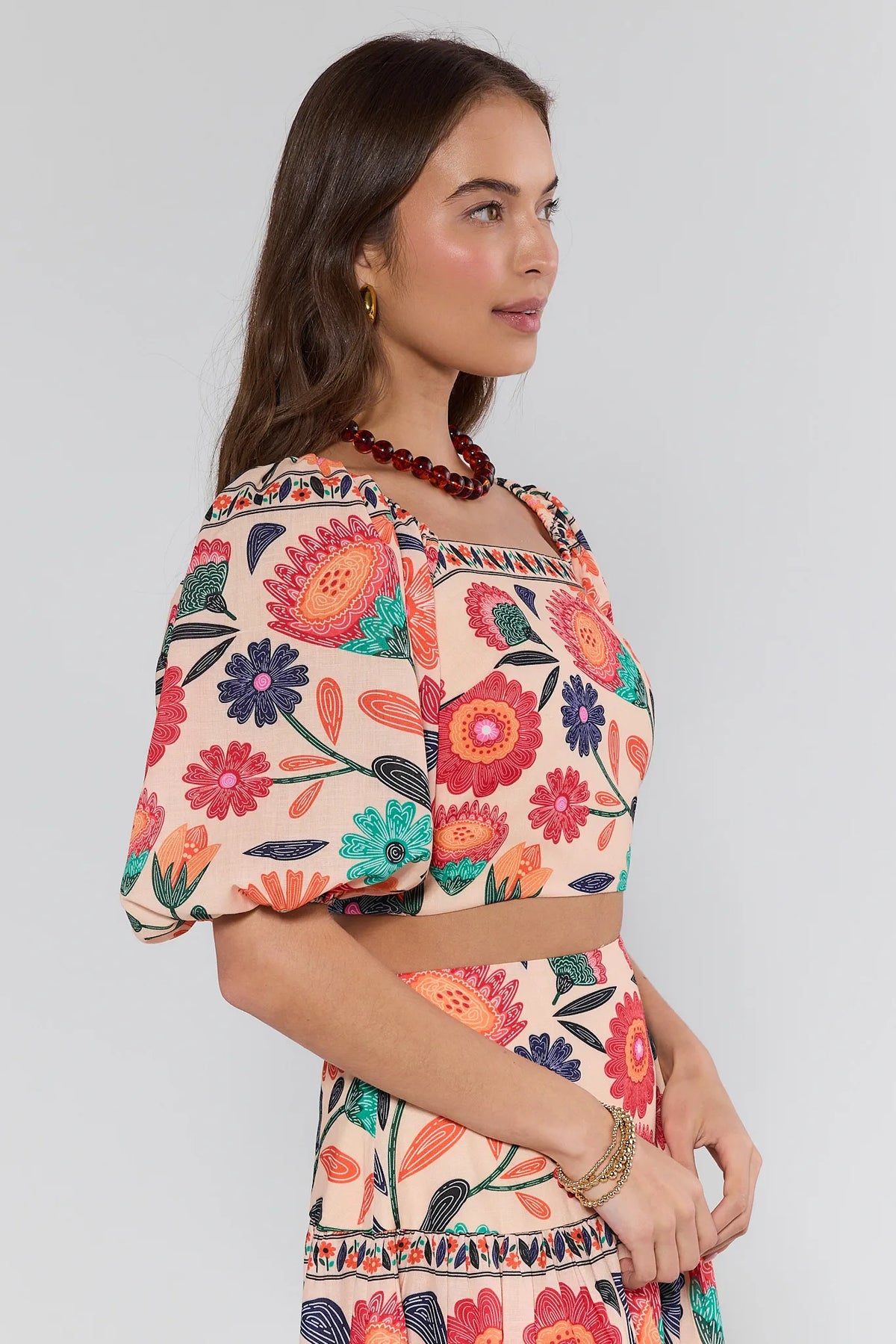 Serena Orange Printed Crop Top - Side Profile with Puff Sleeve Detail | Avara