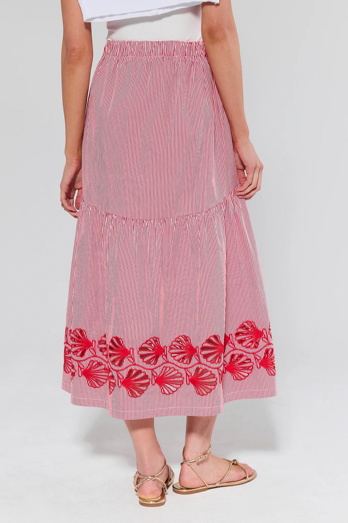Red and white striped skirt with floral embroidery on a white background