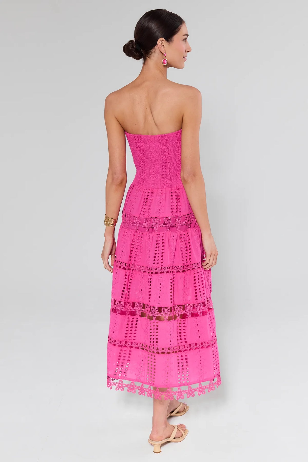 Hot pink eyelet tiered midi dress back view showing smocked bodice — Cecilia Pink Strapless Midi Dress | Avara