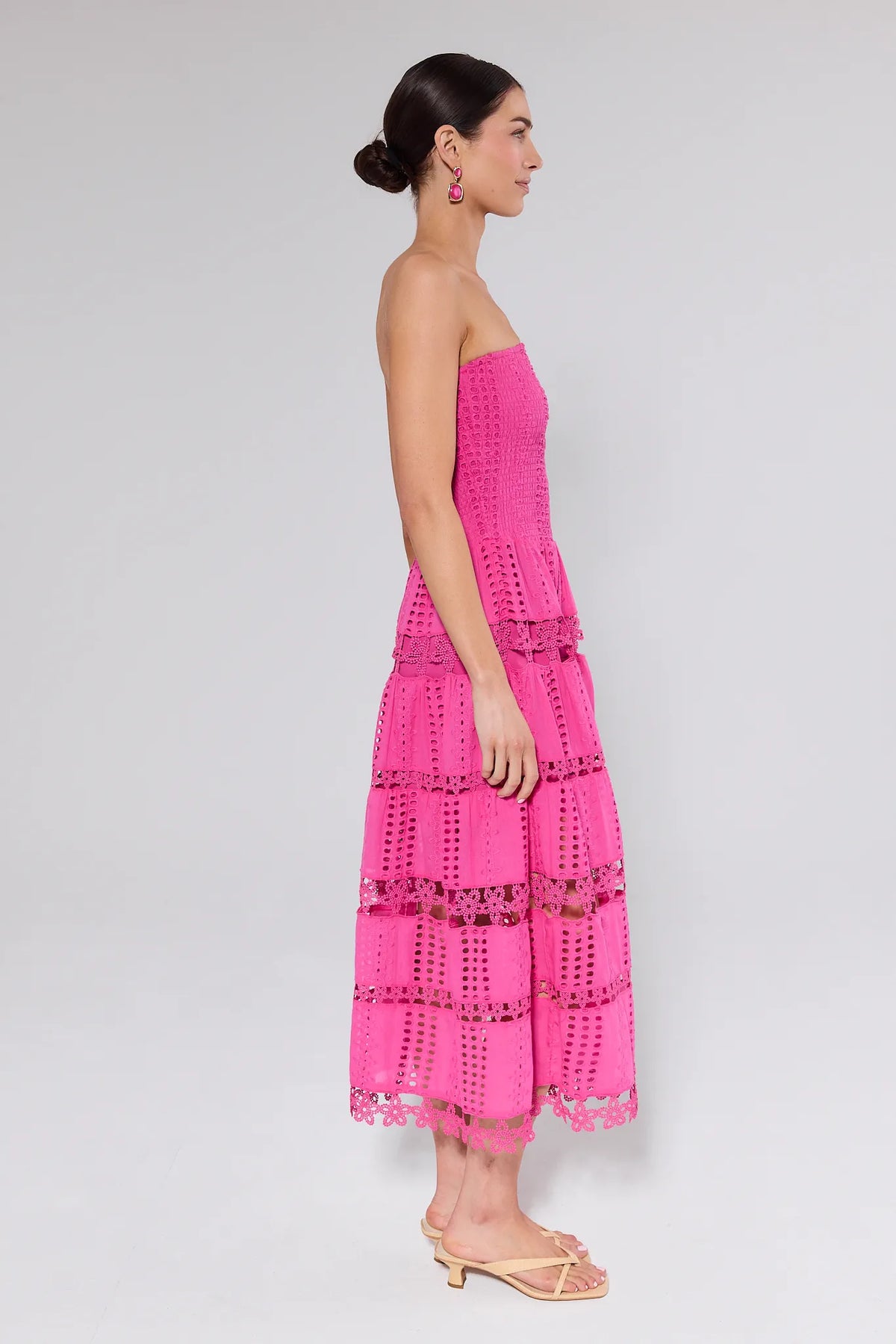 Hot pink strapless tiered eyelet midi dress, side profile view — Cecilia Pink Strapless Midi Dress | Avara
